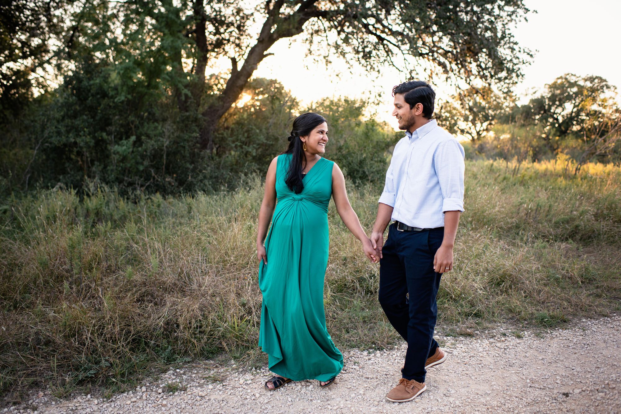 Couple walking and smiling at each other, Lifestyle San Antonio Maternity Photography