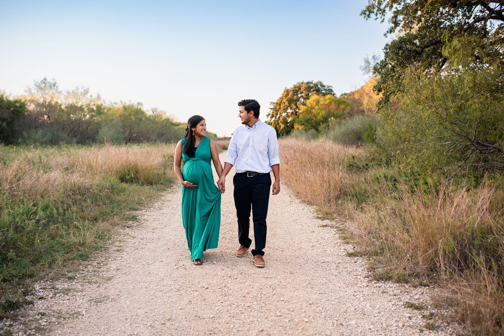 Pregnant couple walking together on a trial, San Antonio Maternity Photographer