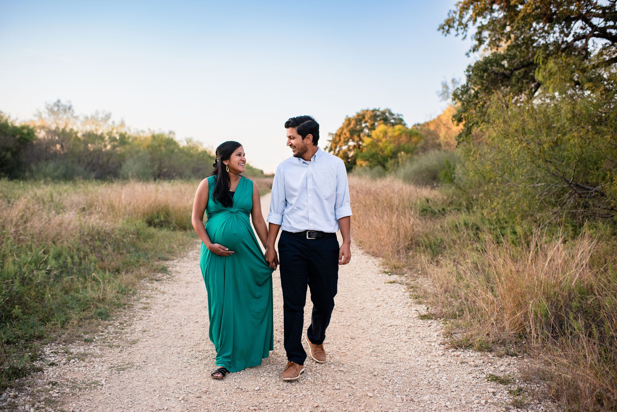 San Antonio Maternity Photographer, Pregnant couple walking together on a trial