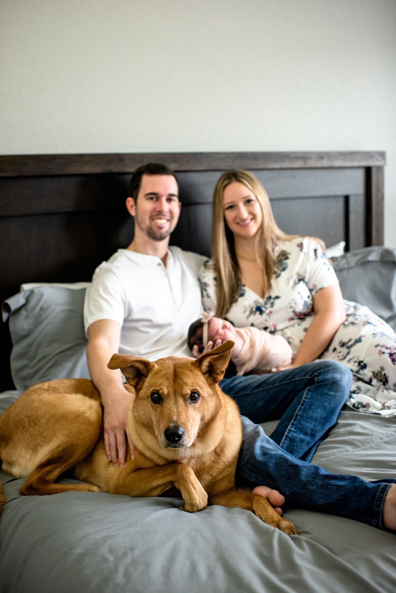 Couple on bed with baby and dog, San Antonio Lifestyle Newborn Photographer