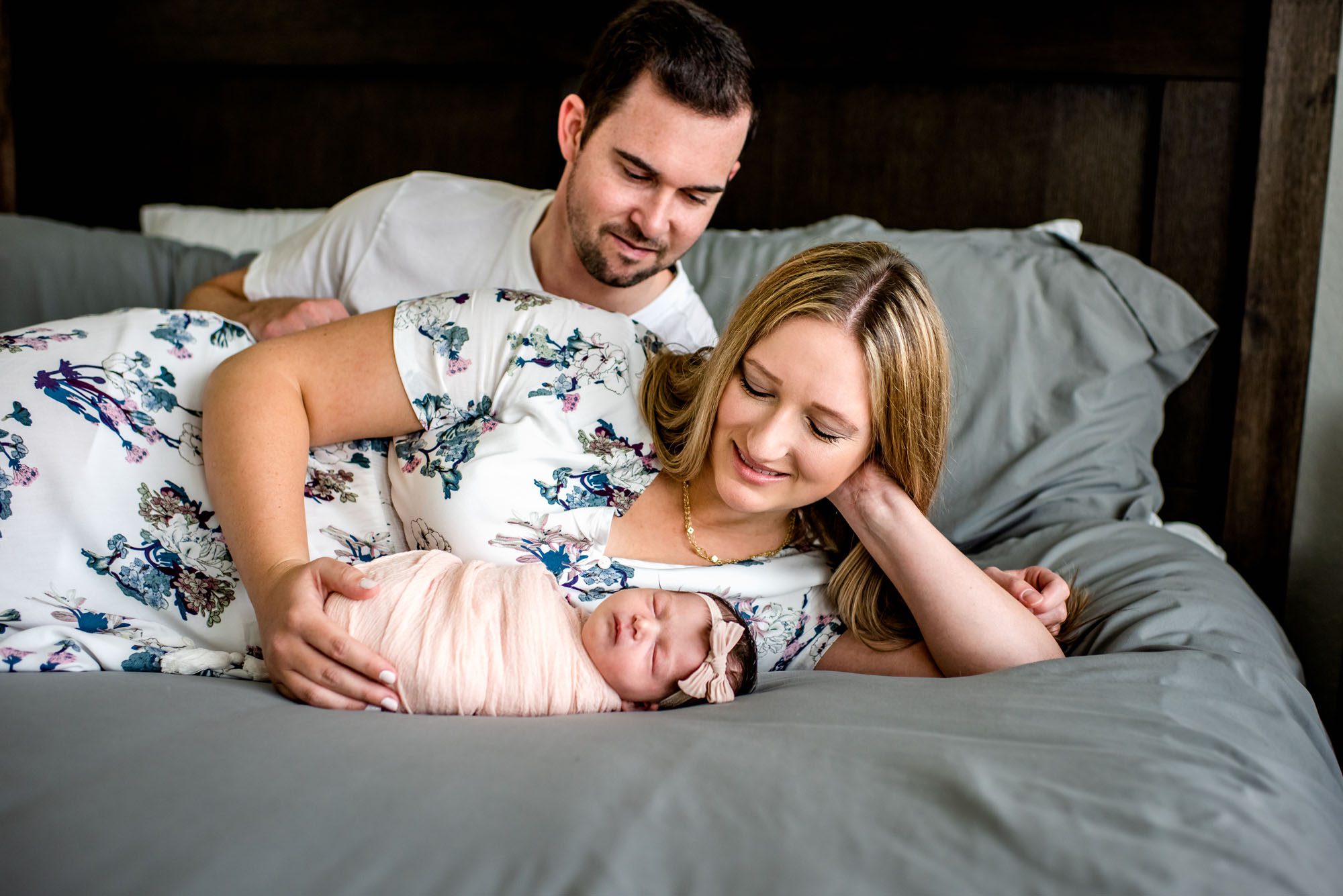 Couple on bed with newborn baby, San Antonio Newborn Photographer
