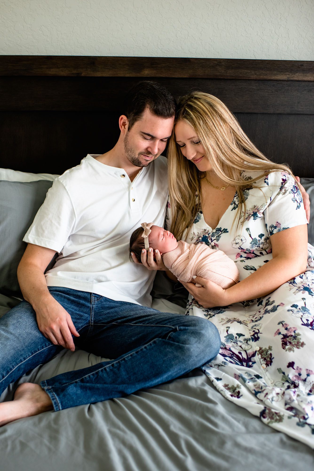 Couple on bed smiling at baby, San Antonio Newborn Photographer