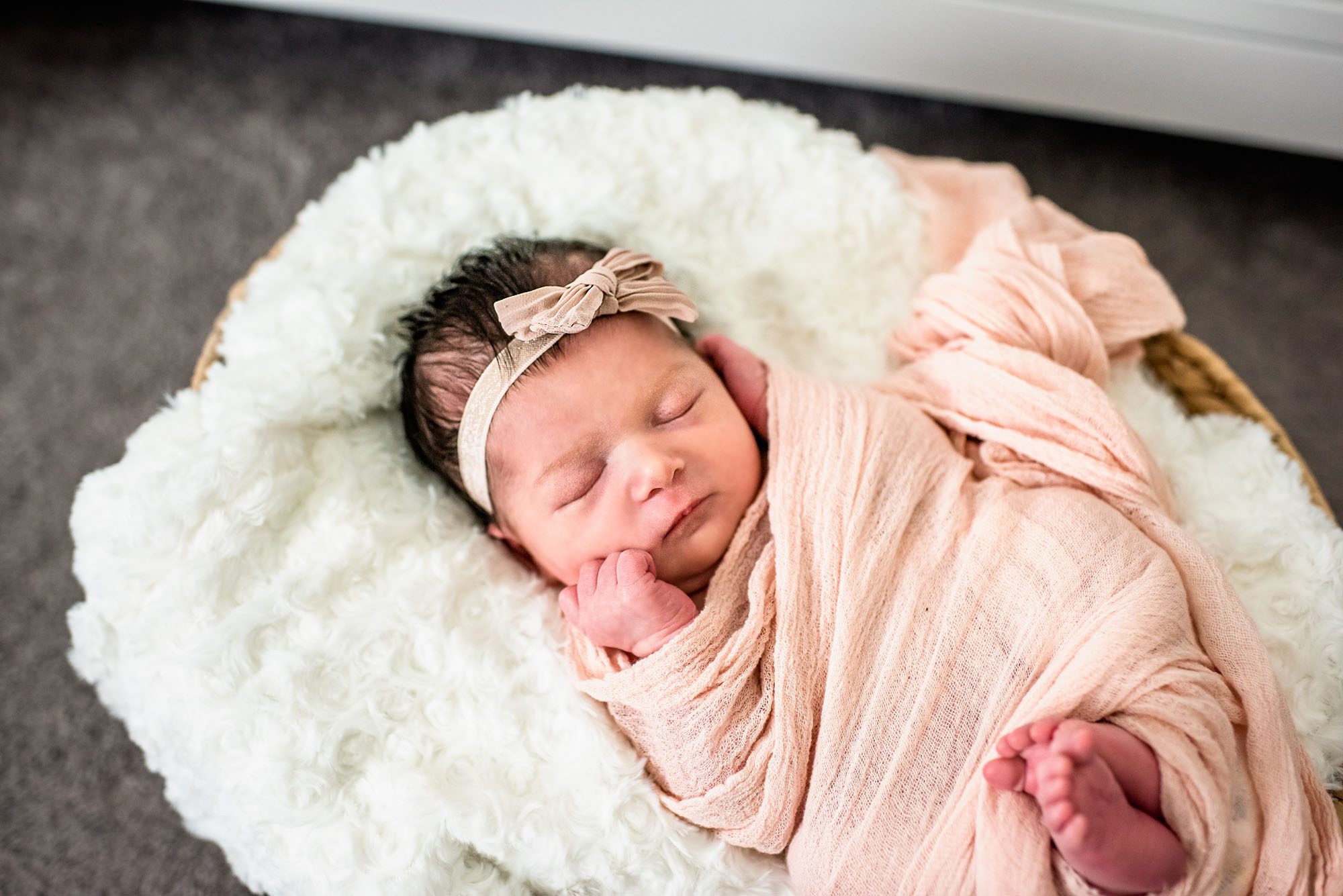 Newborn girl asleep in basket, Newborn Photographer