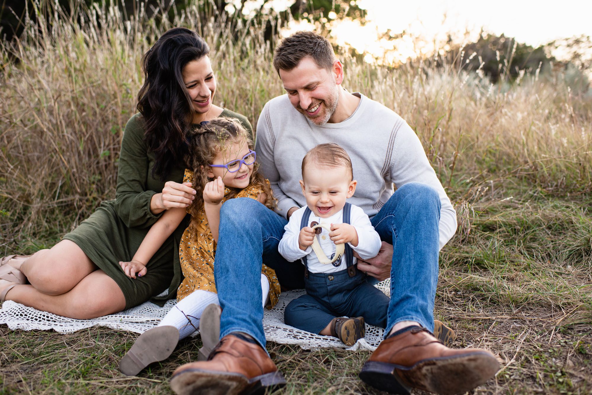 Family sitting on a blanket in the grass, San Antonio Family Photographer