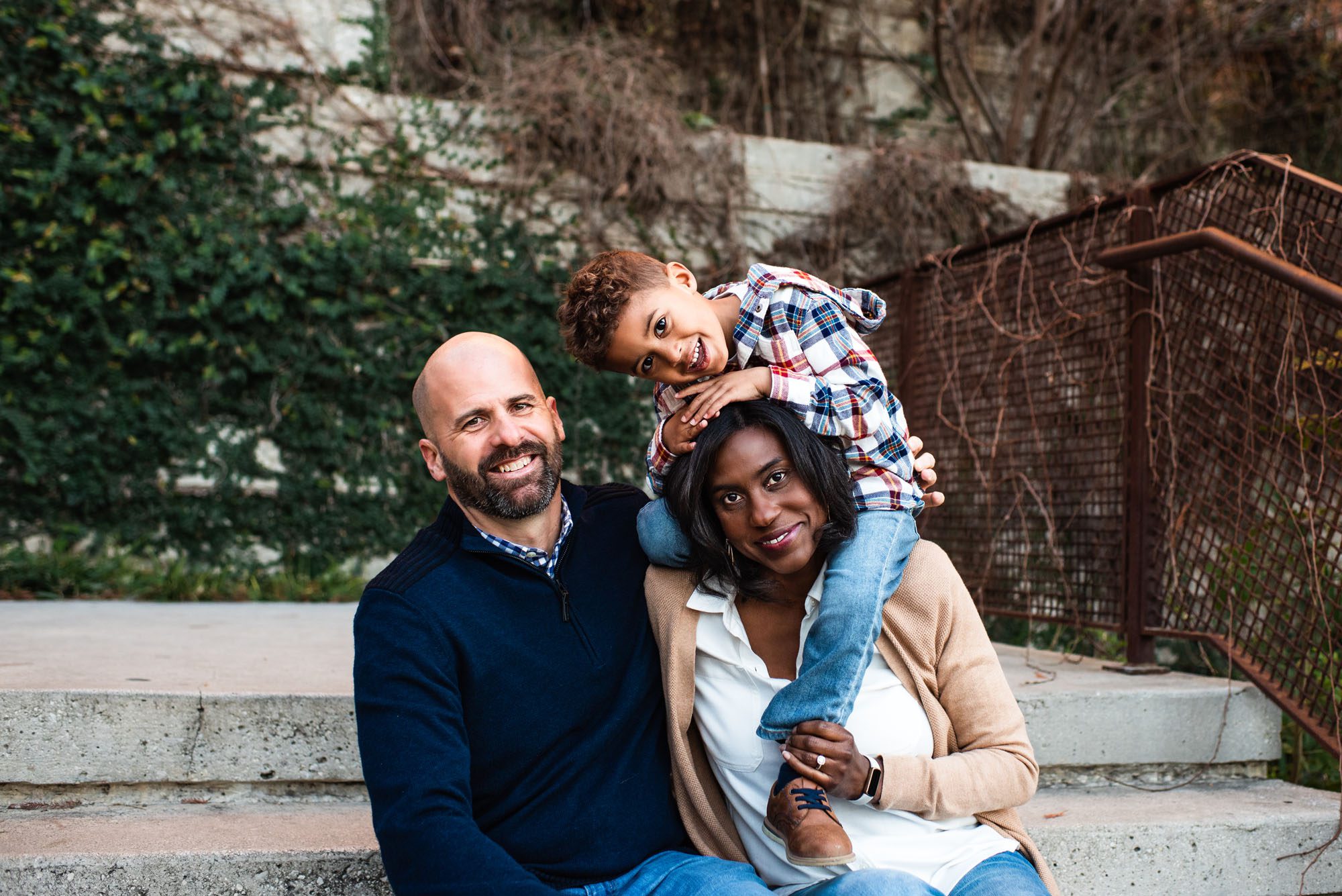 Family sitting on staircase with son, Family Photographer San Antonio