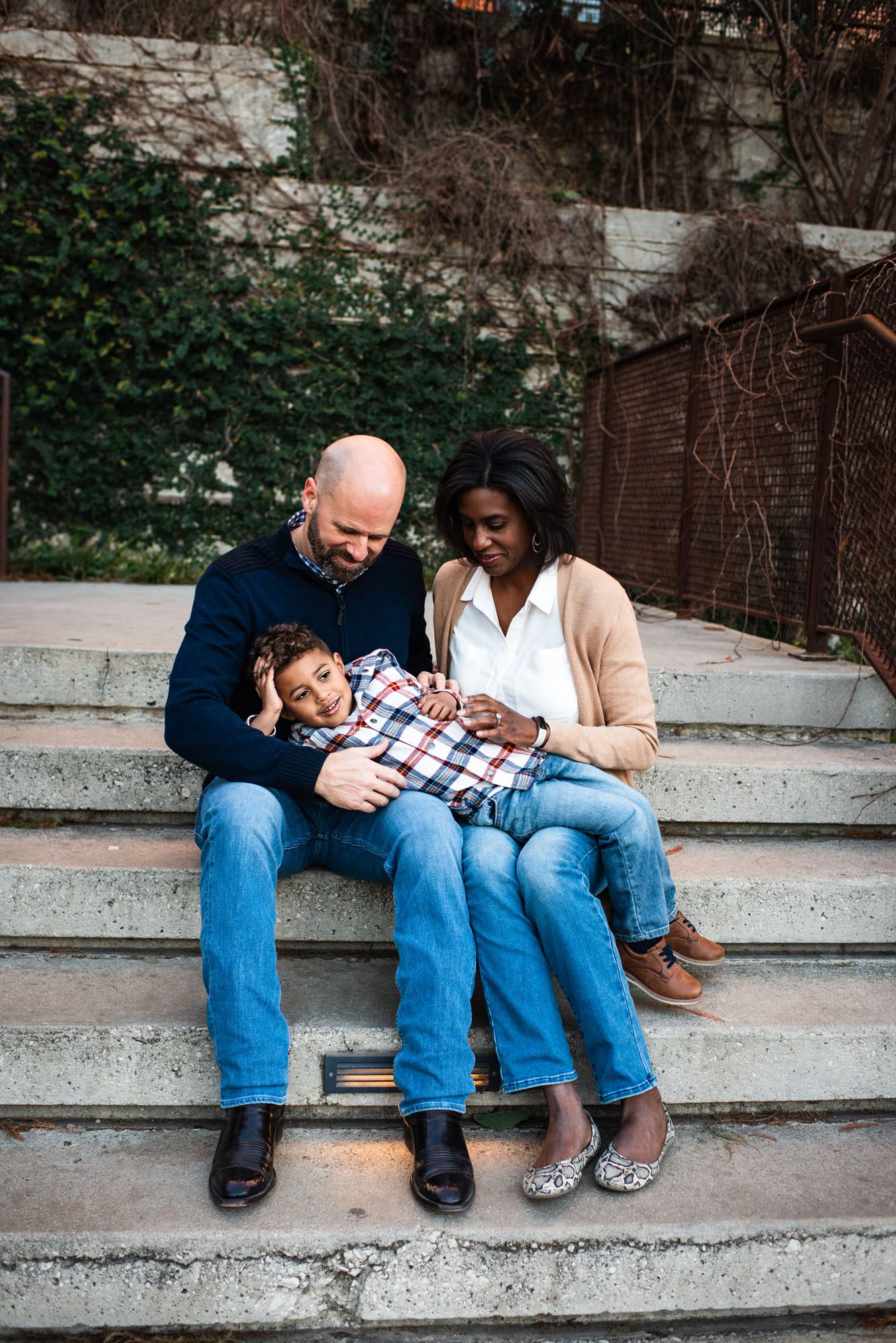 Family sitting on staircase tickling son, Family Photographer San Antonio