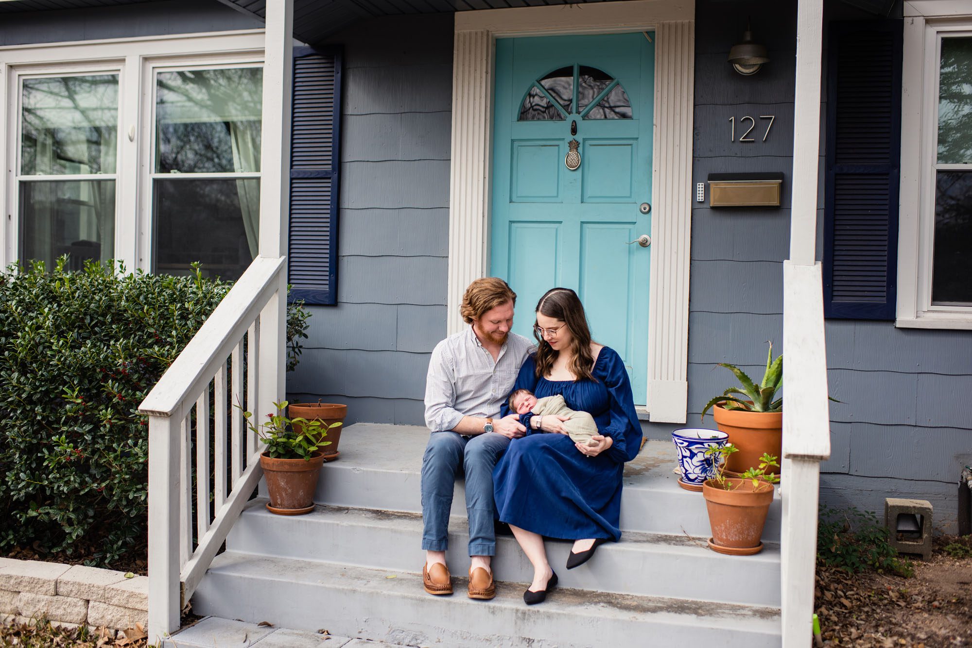 Couple sitting on front porch with baby, San Antonio Lifestyle Newborn Photographer