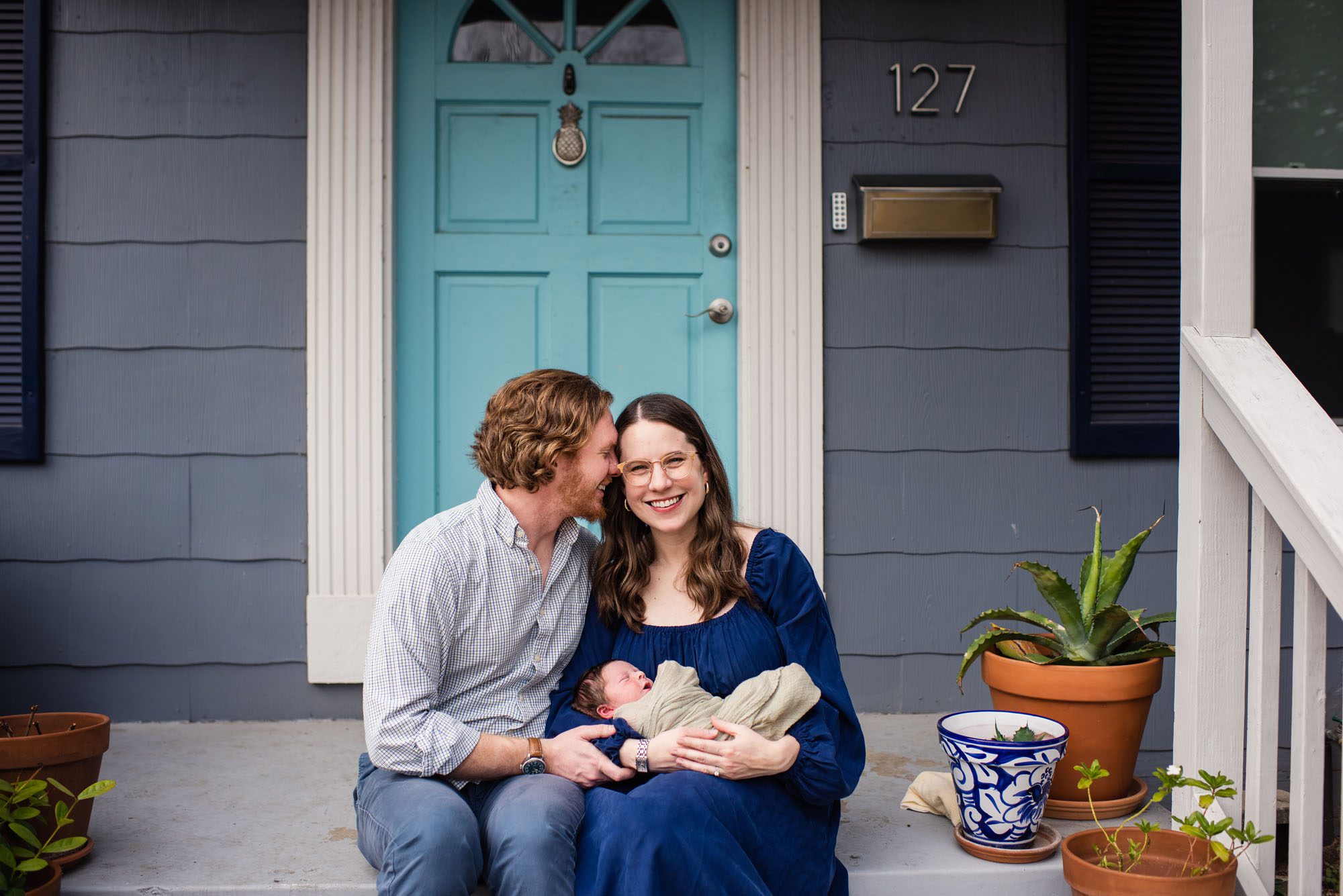 Couple sitting on front porch with baby, San Antonio Lifestyle Newborn Photographer