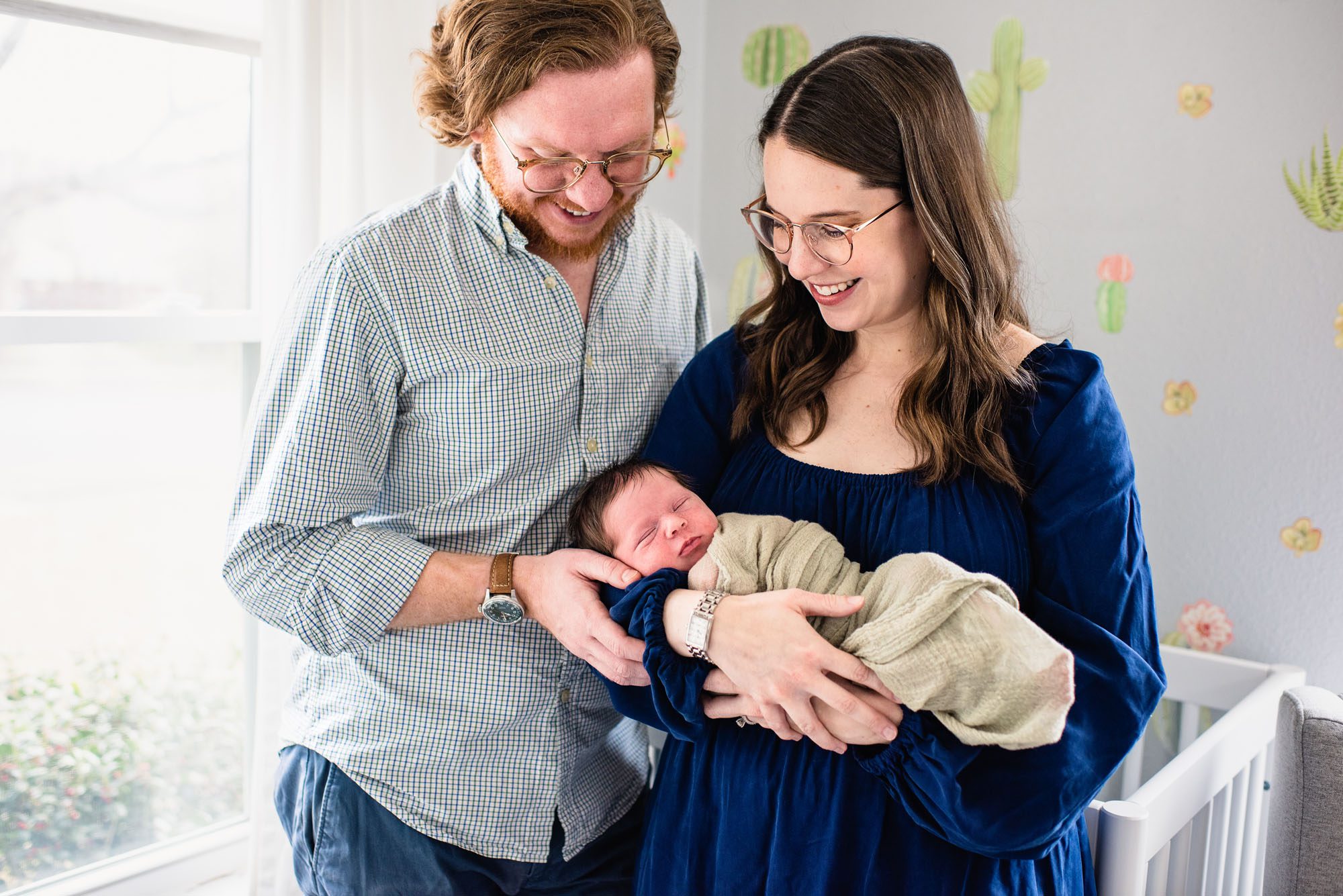 San Antonio Newborn Photographer, Couple holding newborn baby in nursery