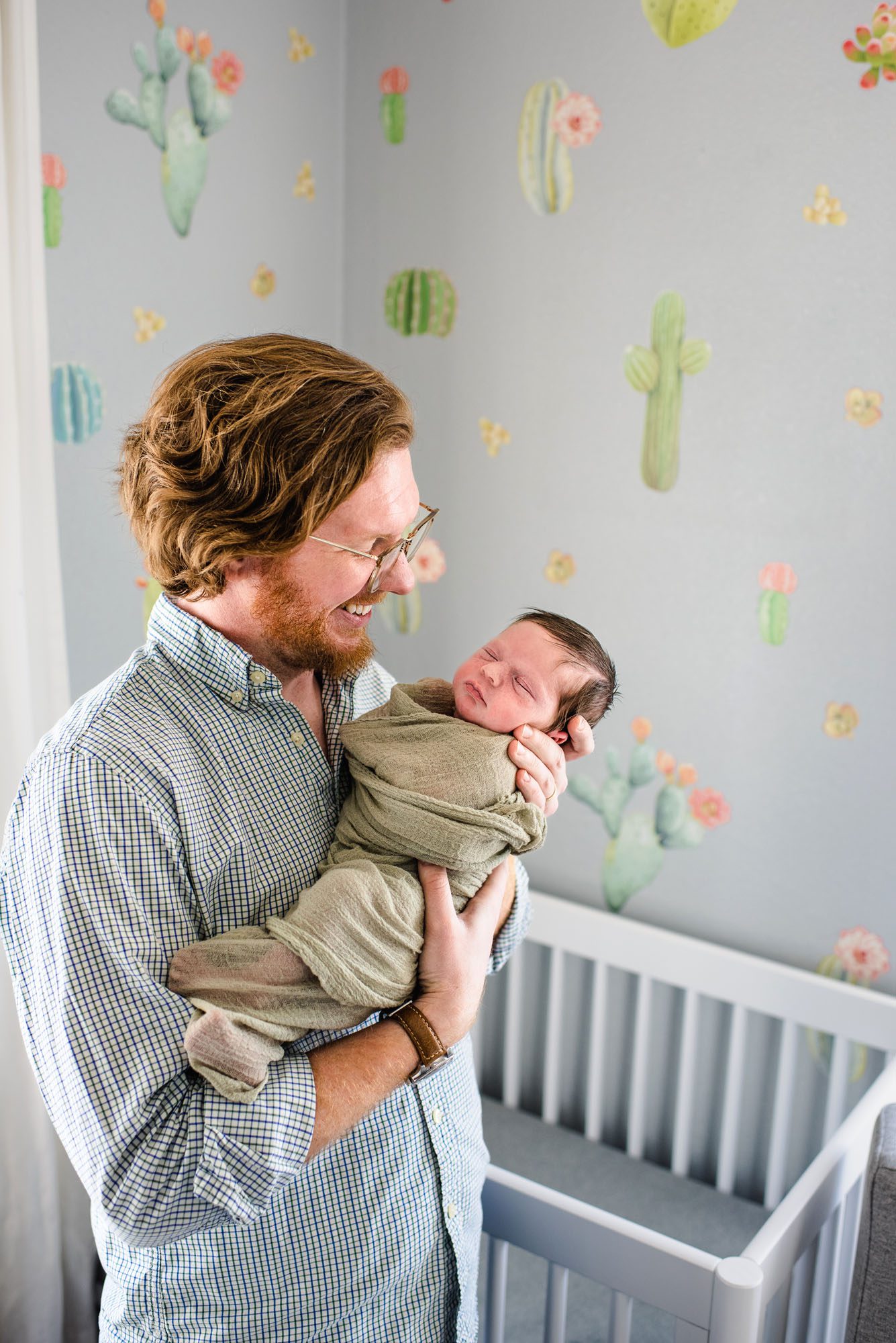 San Antonio Newborn Photographer, Dad smiling at baby boy in nursery