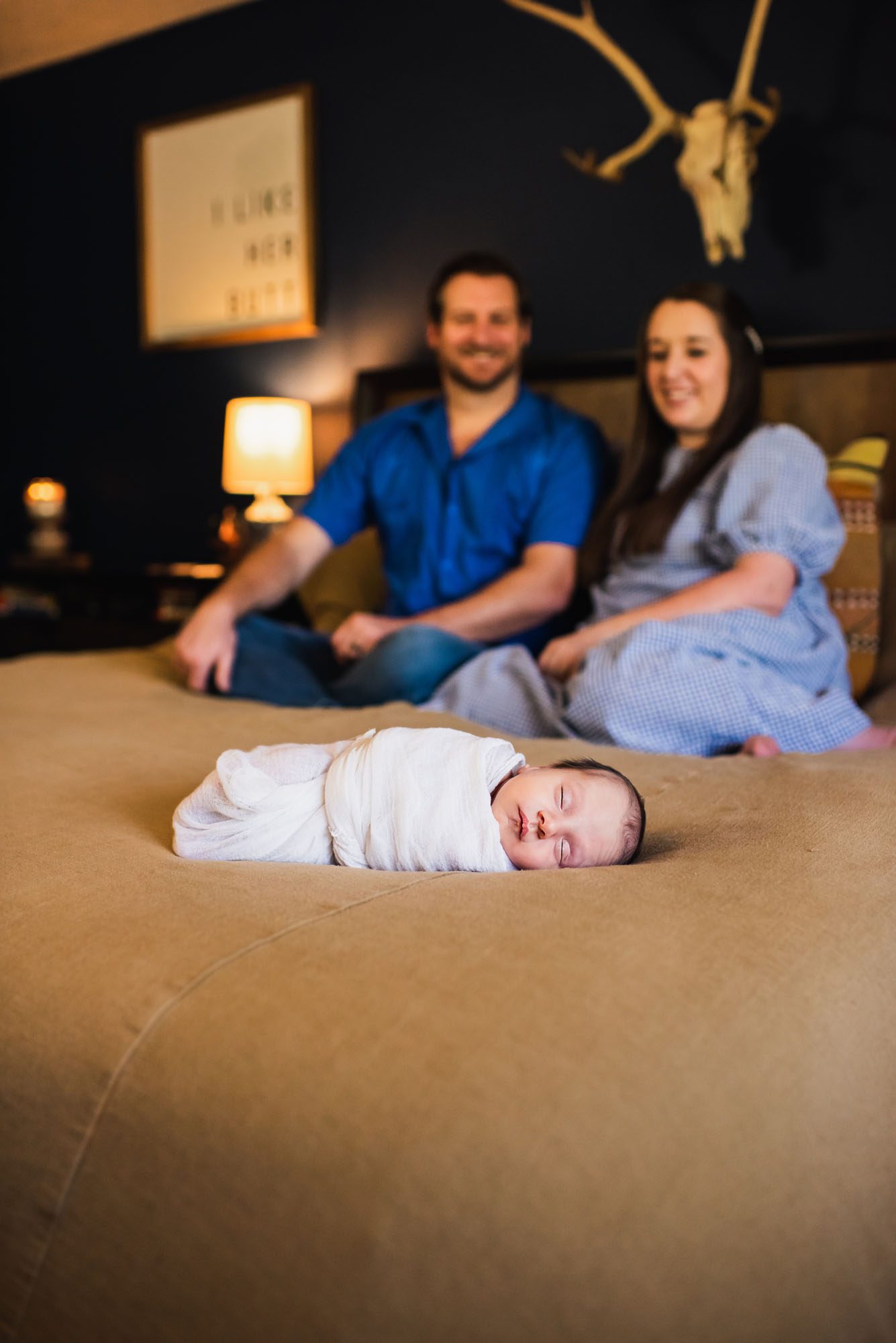 San Antonio Newborn Photographer, baby sleeping on bed with parents in the background