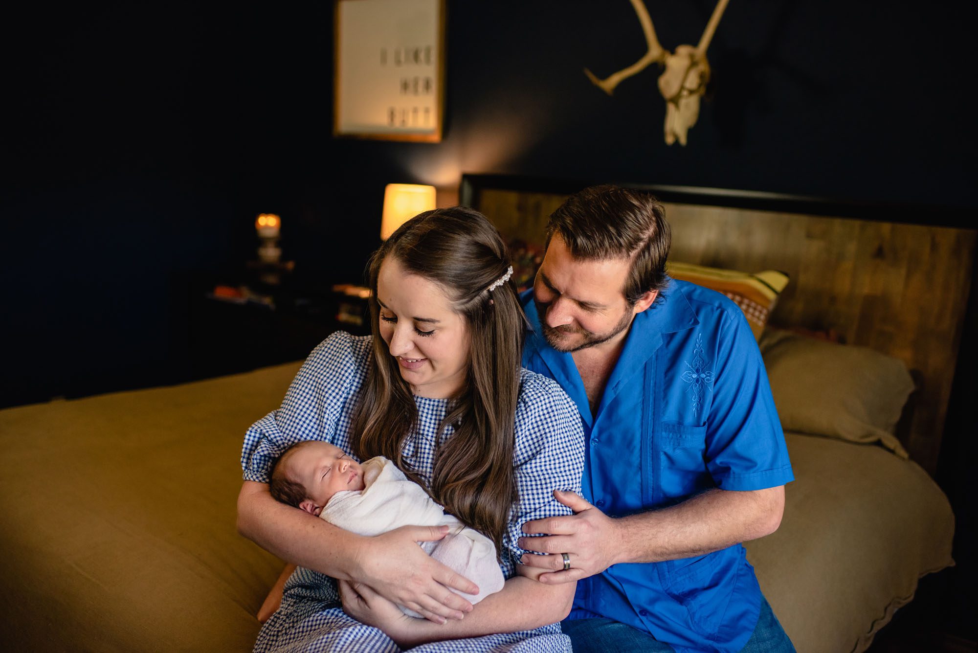 San Antonio Newborn Photographer, Couple holding newborn baby on bed