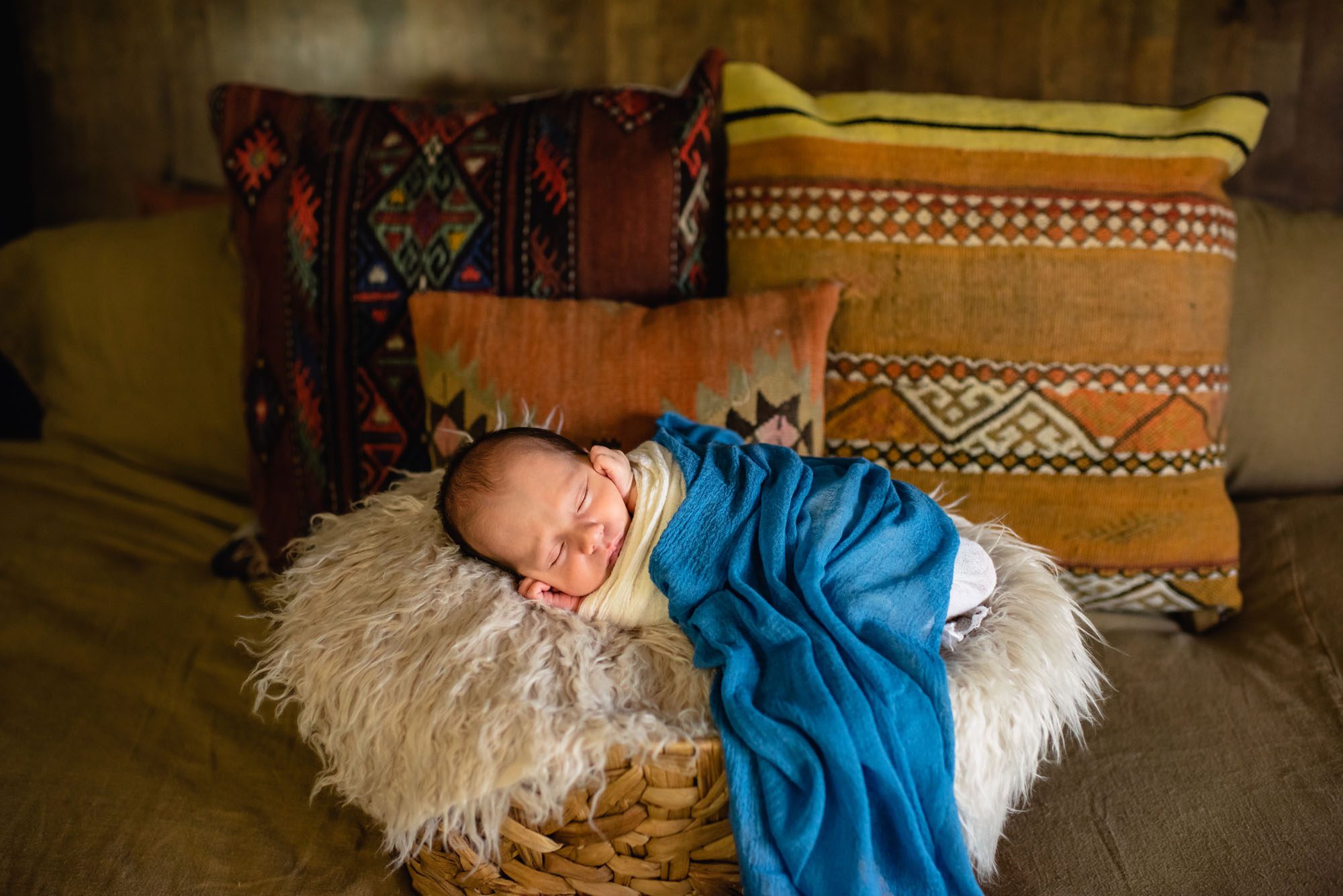 Baby asleep in basket on bed, San Antonio Newborn Photographer