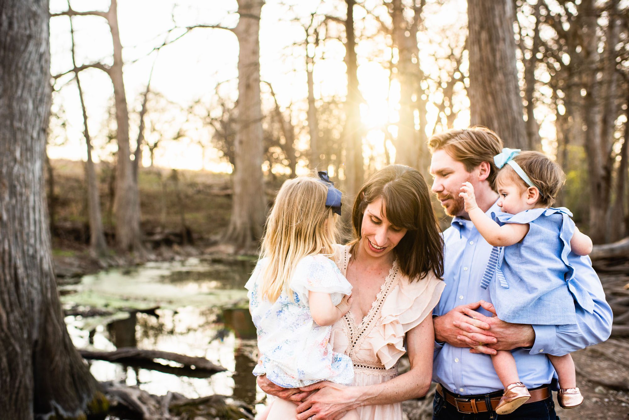 Candid family moment by river bank, San Antonio family lifestyle photographer