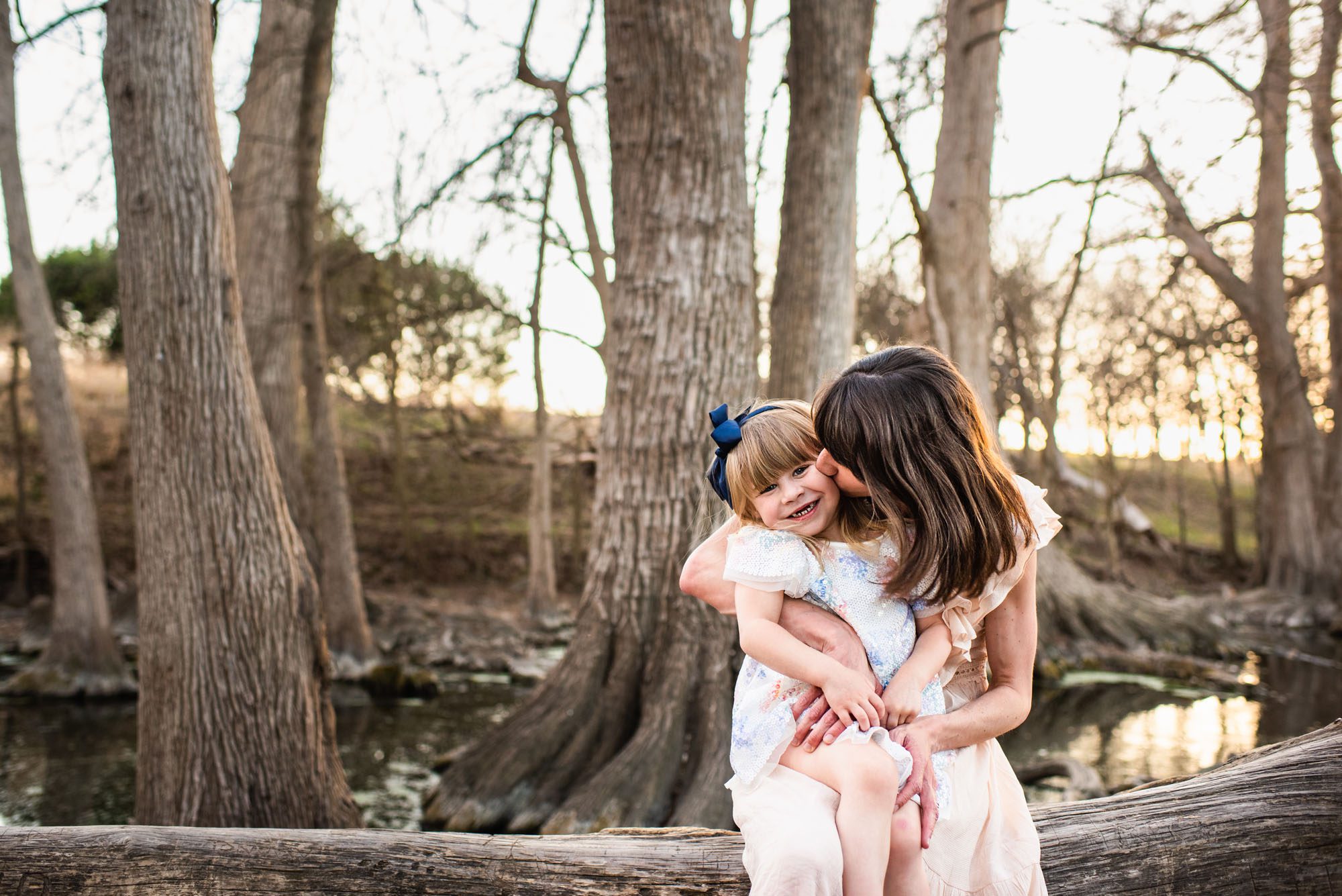 Mom kissing daughter's cheek, San Antonio family lifestyle photographer