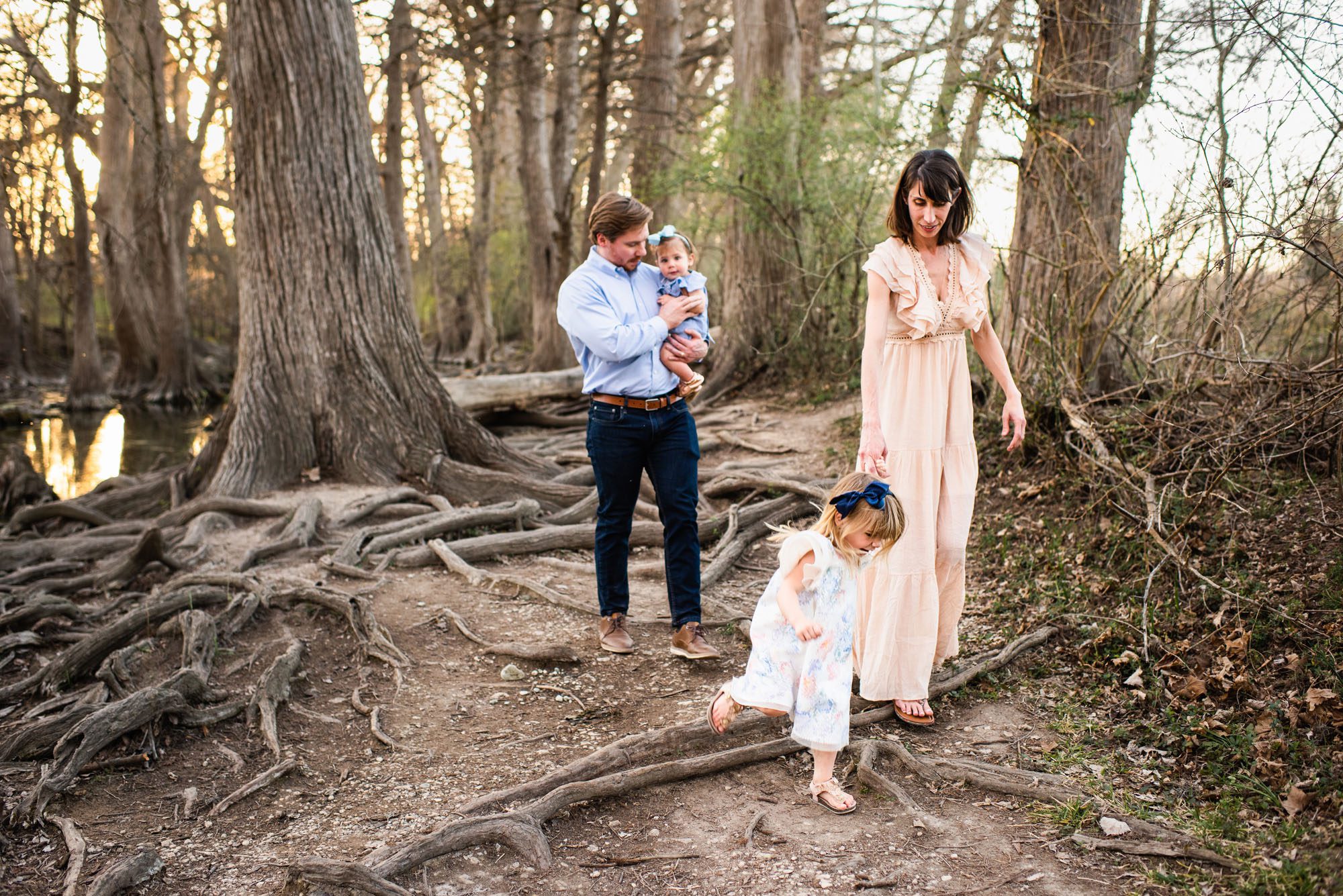 Family walking by the river holding hands, San Antonio family lifestyle photographer
