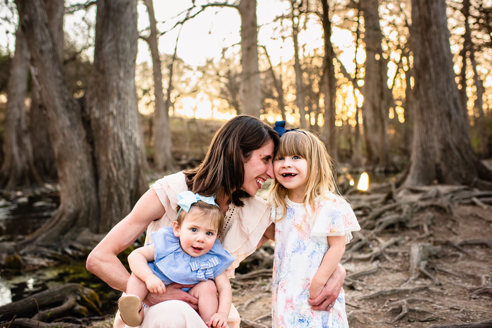 Mother with daughters by the river bank, San Antonio family photographer