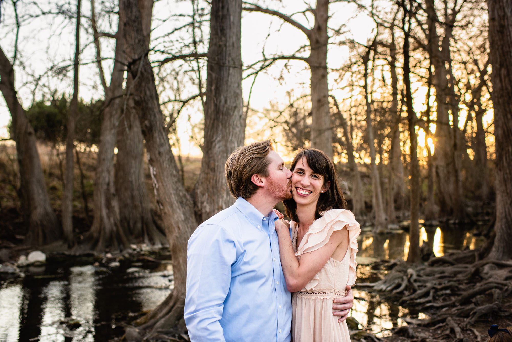Husband kissing wife's cheek, San Antonio river photographer