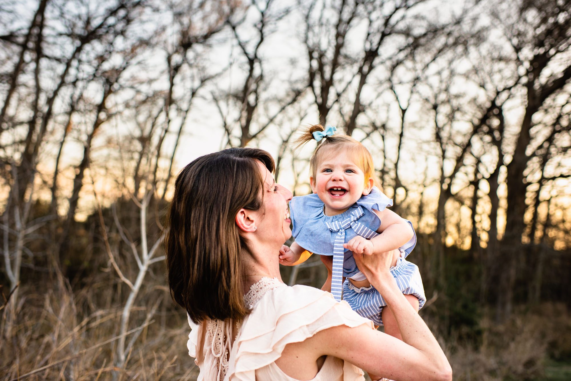 Mom holding up baby with big smile, San Antonio Lifestyle Photographer