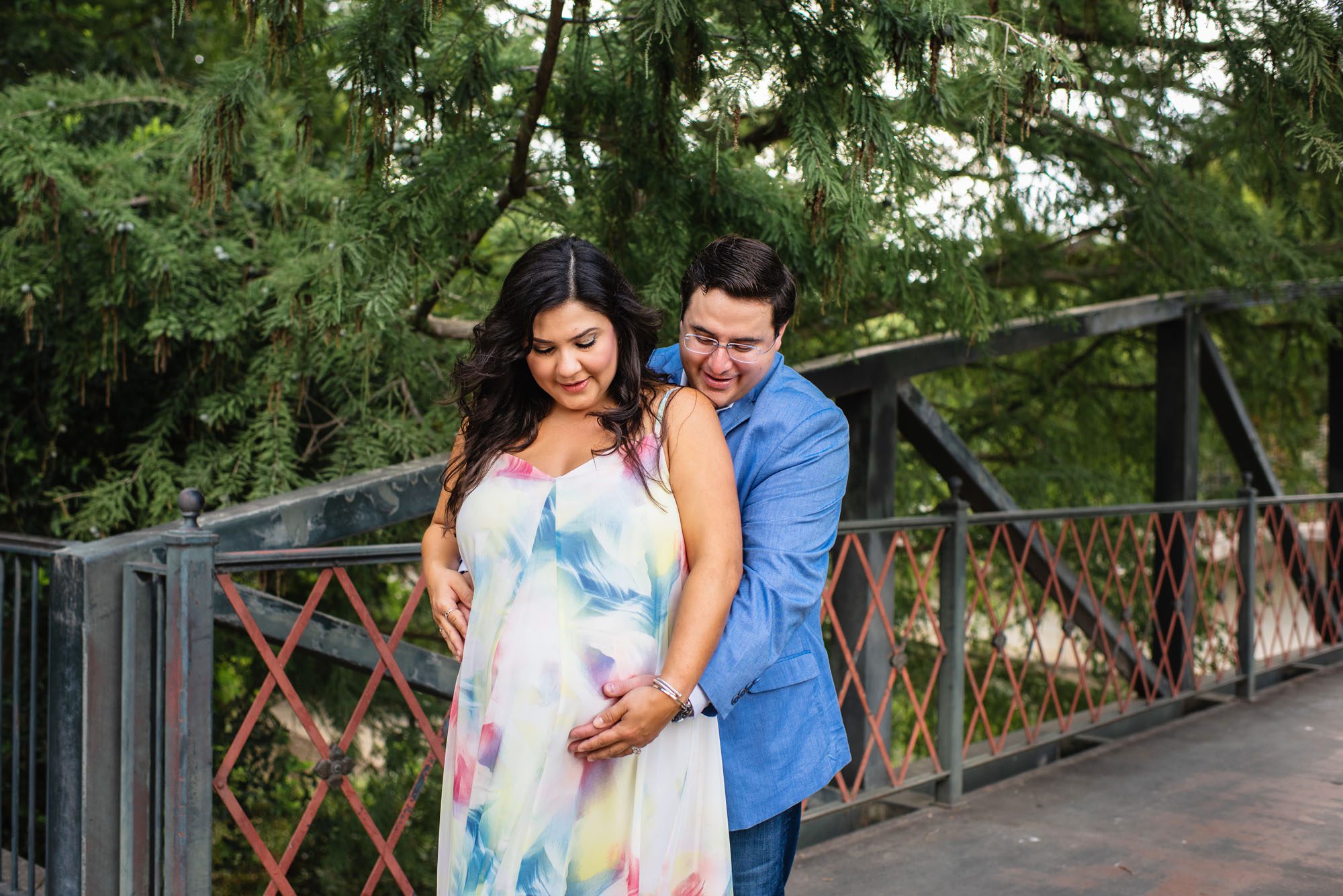 Expectant couple looking at belly, San Antonio Lifestyle Maternity Photographer