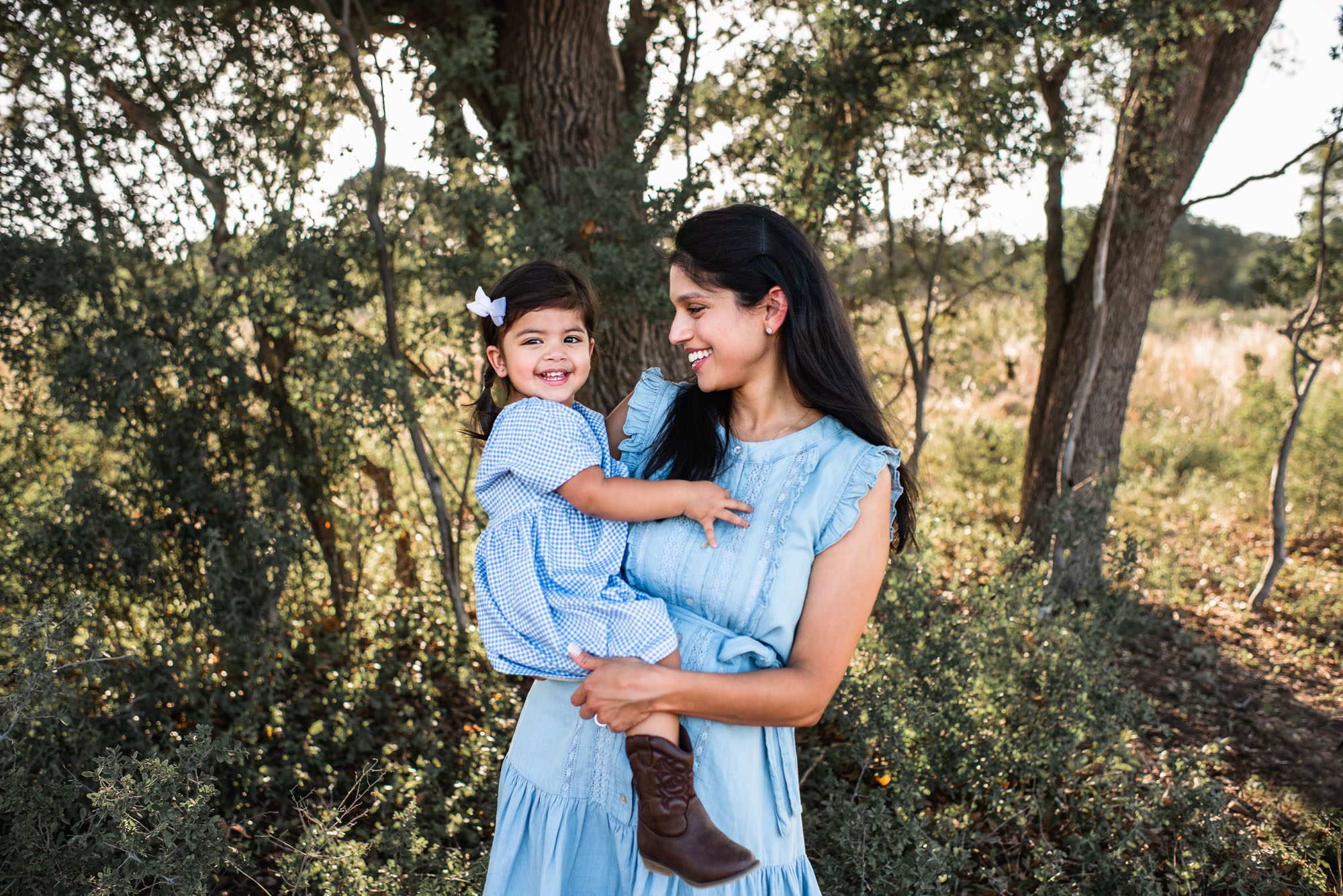 Mother smiling at daughter, San Antonio maternity photographer