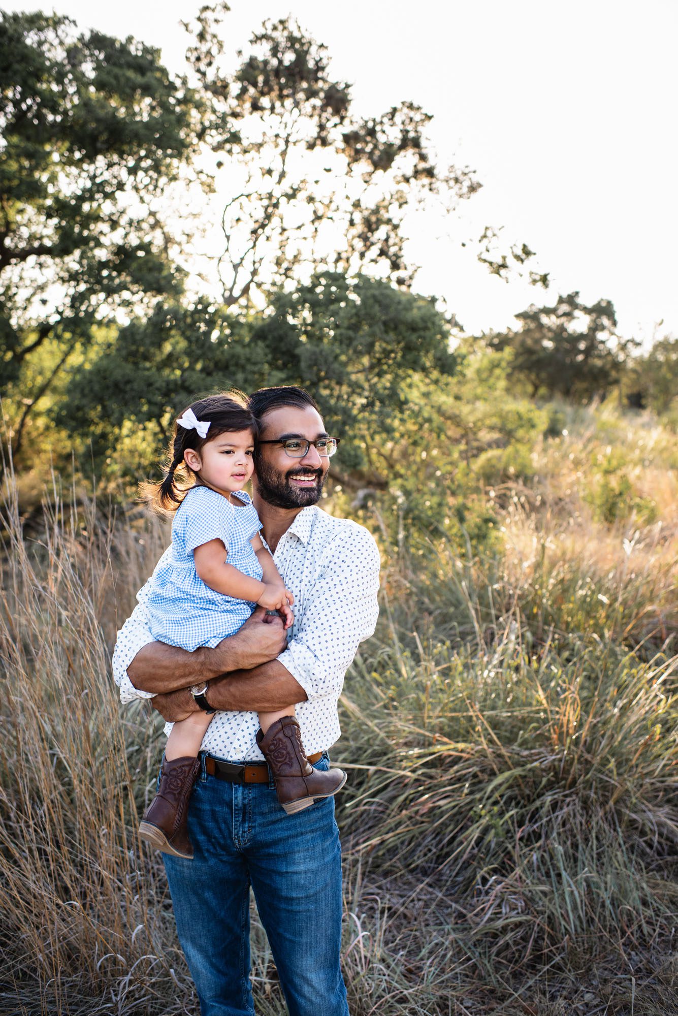 Father holding daughter in a field at sunset, San Antonio lifestyle photographer