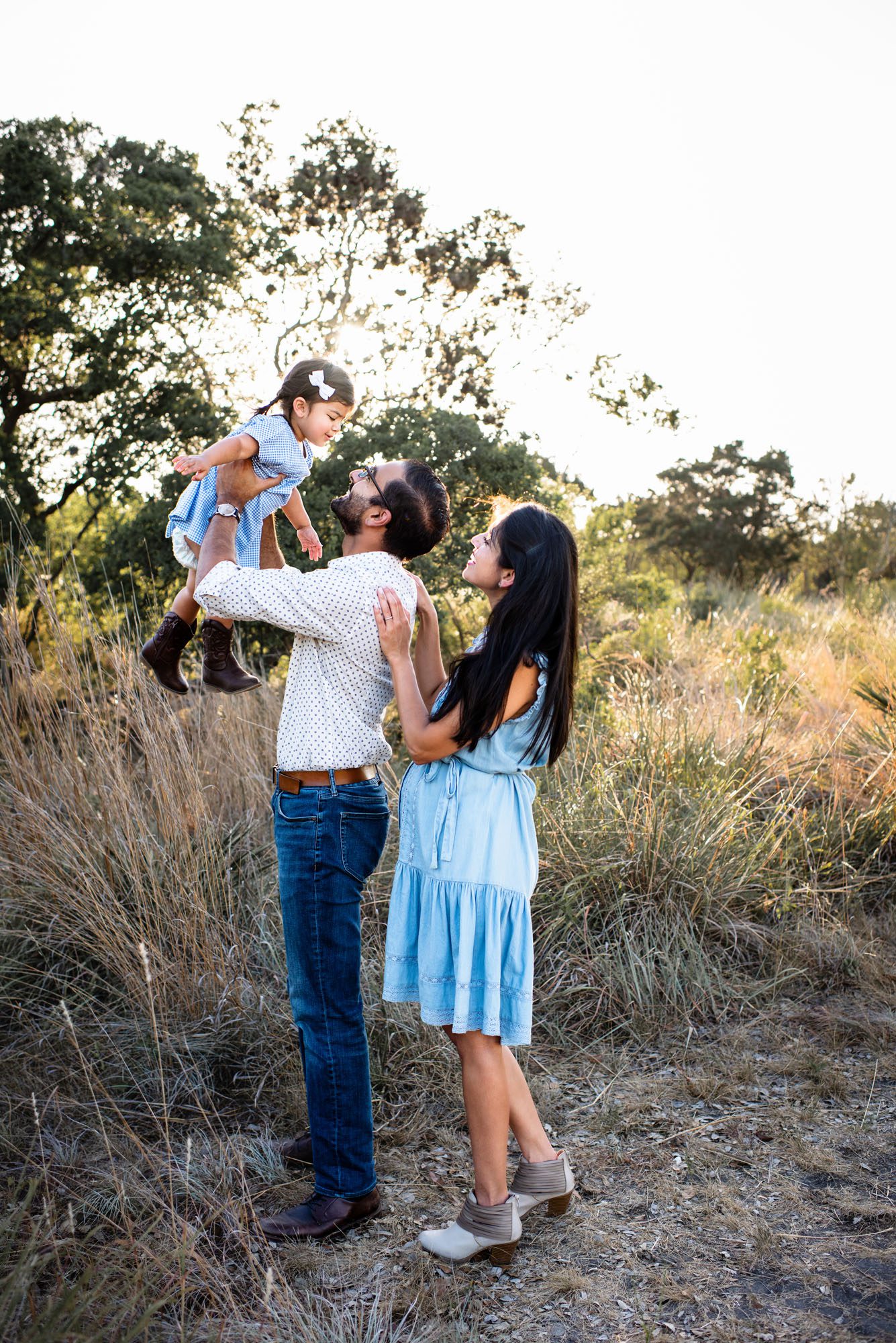 Parents holding daughter up high, San Antonio family photographer
