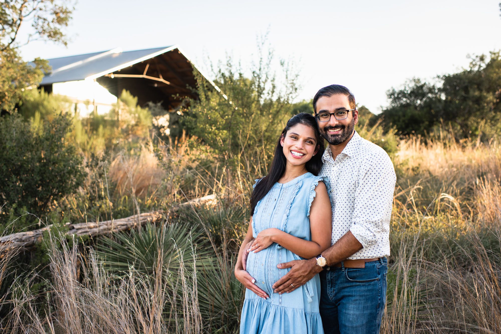 Pregnant couple in a field at sunset, San Antonio maternity photographer