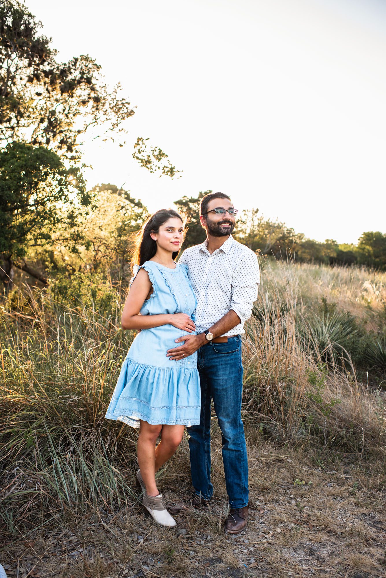 Expectant couple looking out into the field, San Antonio maternity photographer