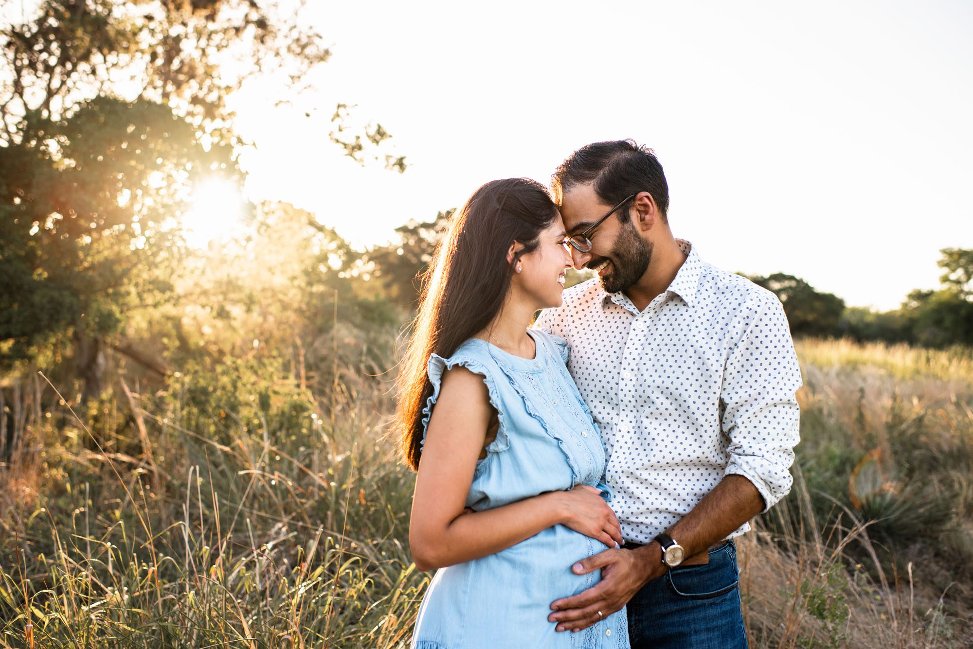 Expectant couple holding each other at sunset, San Antonio lifestyle maternity photographer