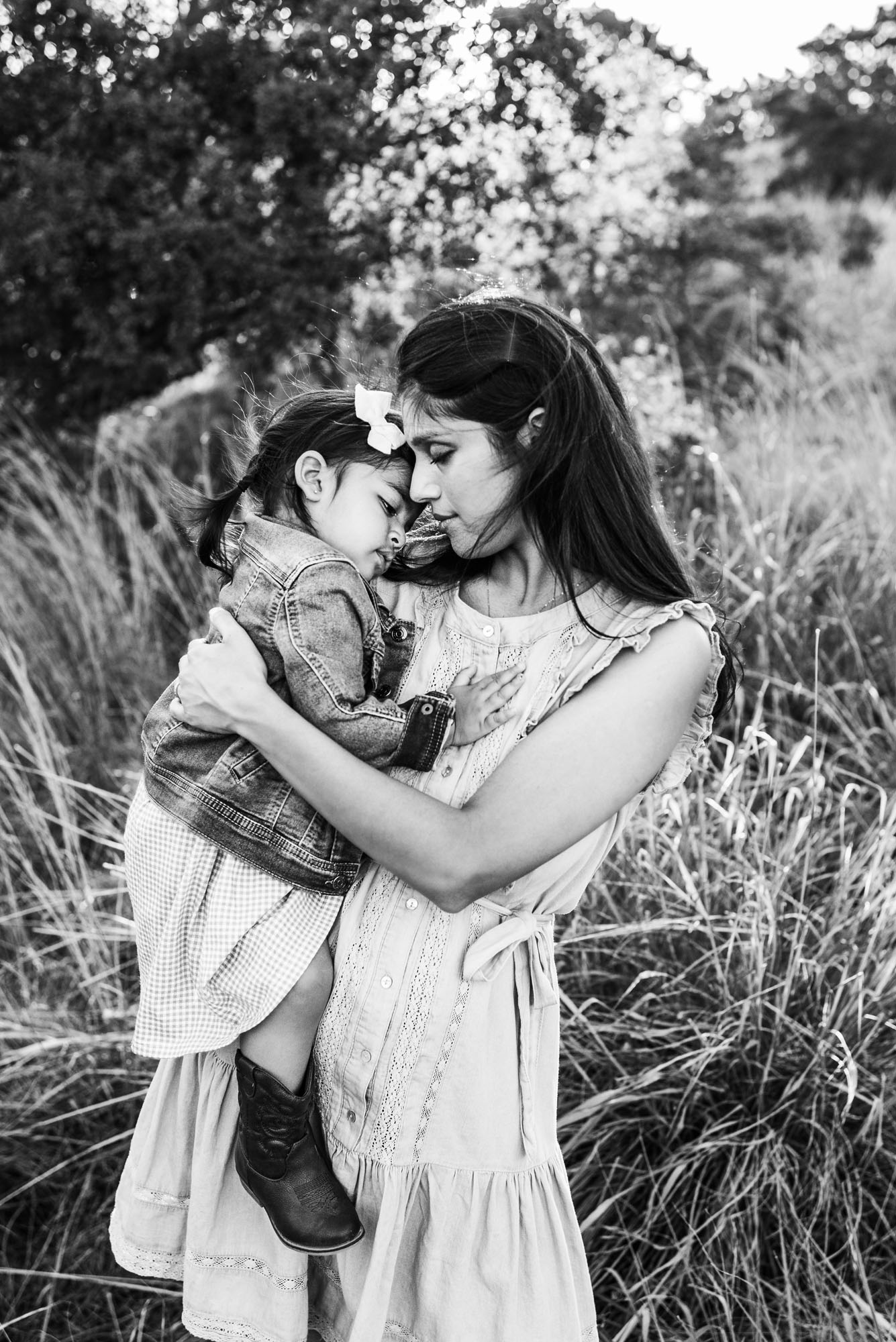 Mother hugging daughter in field, San Antonio lifestyle family photographer