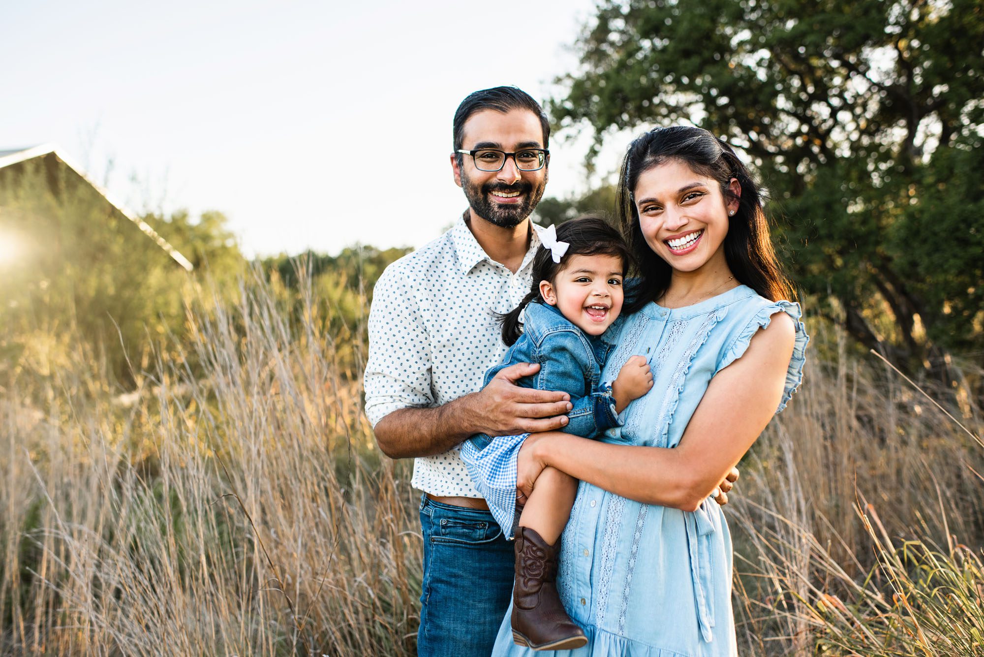 Family smiling together in field, San Antonio area family photographer