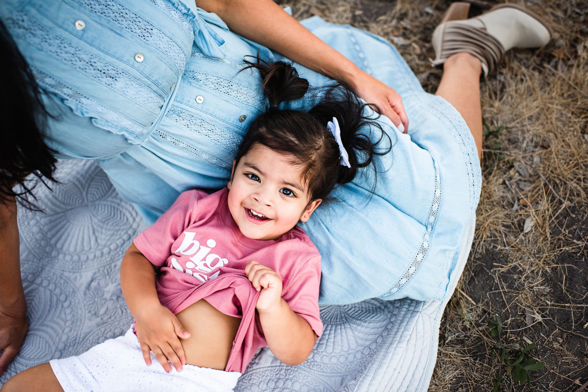 Daughter laying in mother's lap, San Antonio Maternity photography
