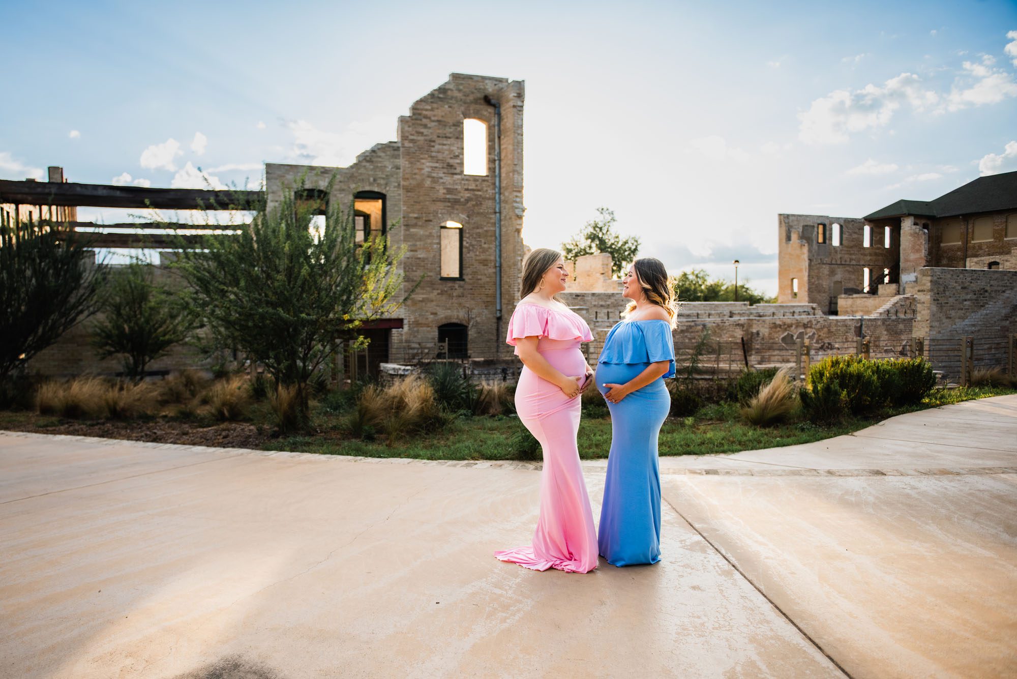 Pregnant sisters standing by building, San Antonio Maternity Photographer