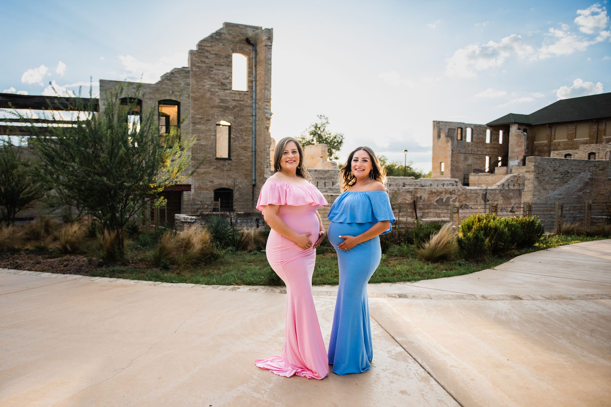Pregnant sisters standing by building, San Antonio Maternity Photographer