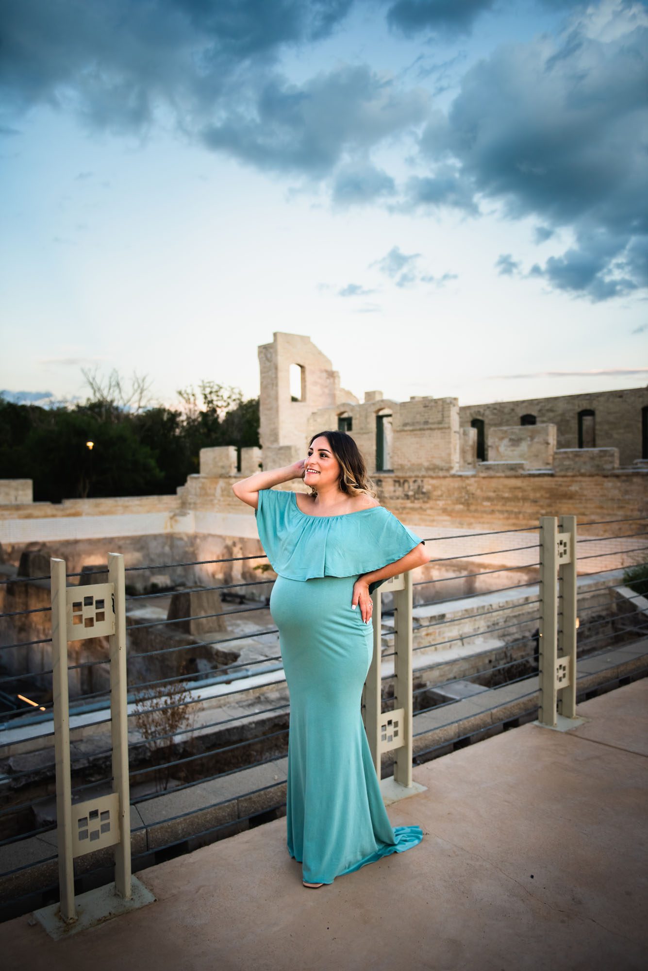 Pregnant mom in green dress with gray clouds, San Antonio Maternity Photography