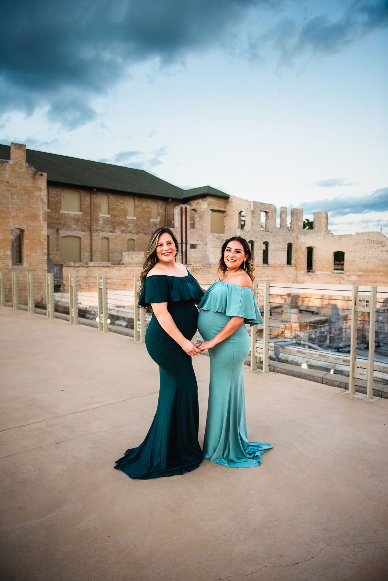 San Antonio Maternity Photographer, pregnant sisters in green dresses holding hands