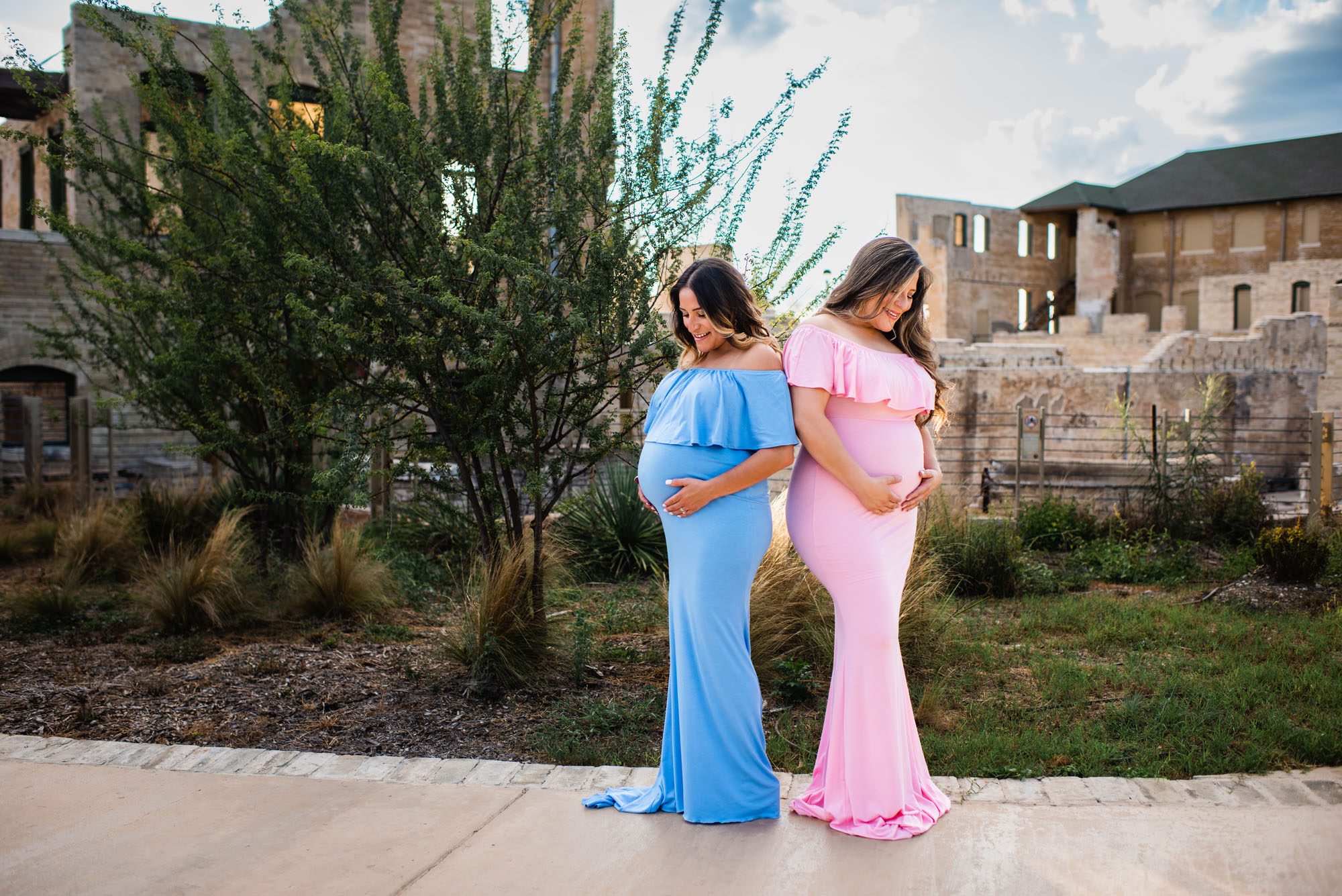 Pregnant sisters looking at their belly bumps, San Antonio Maternity Photographer