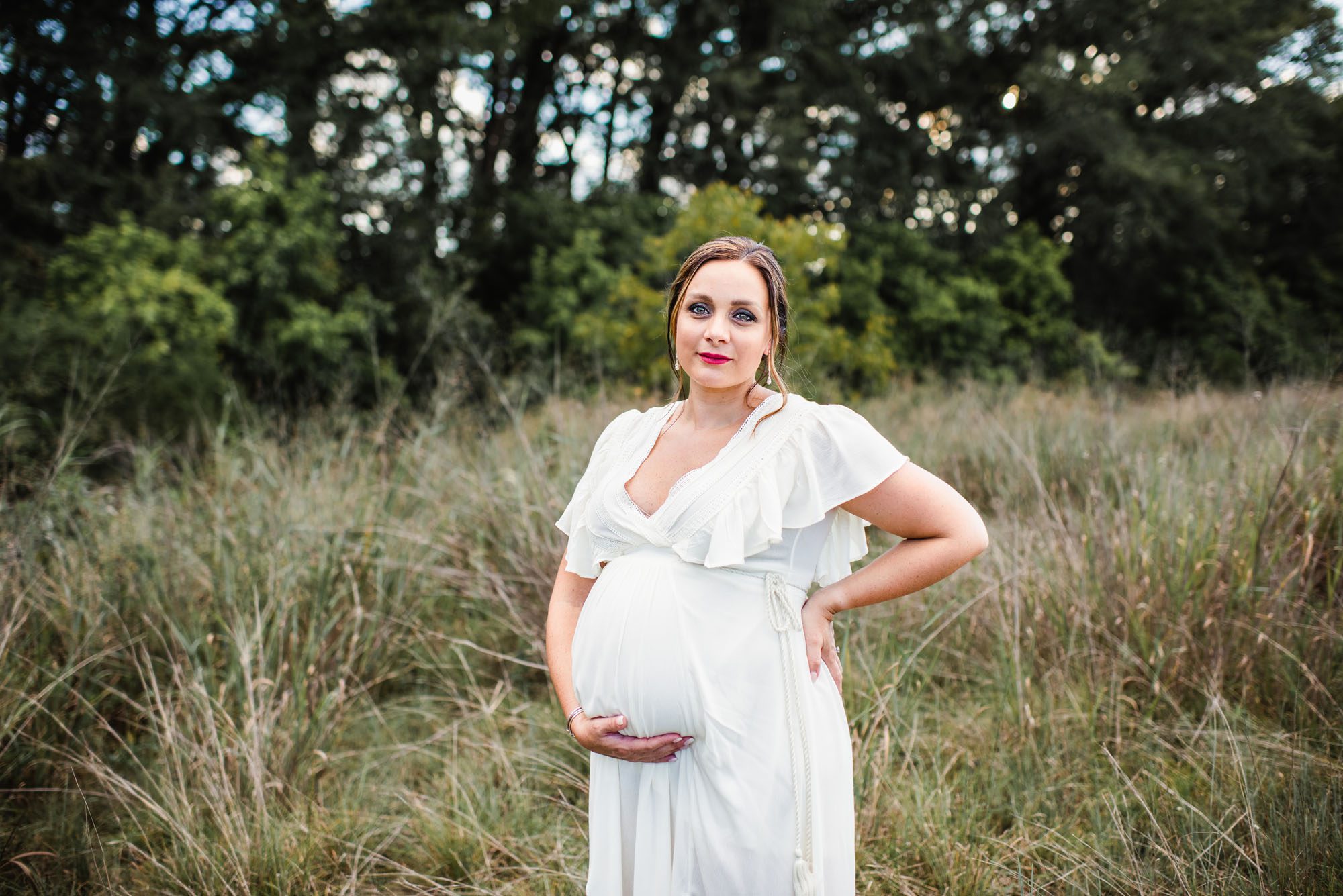 Pregnant woman standing in field, San Antonio maternity photographer