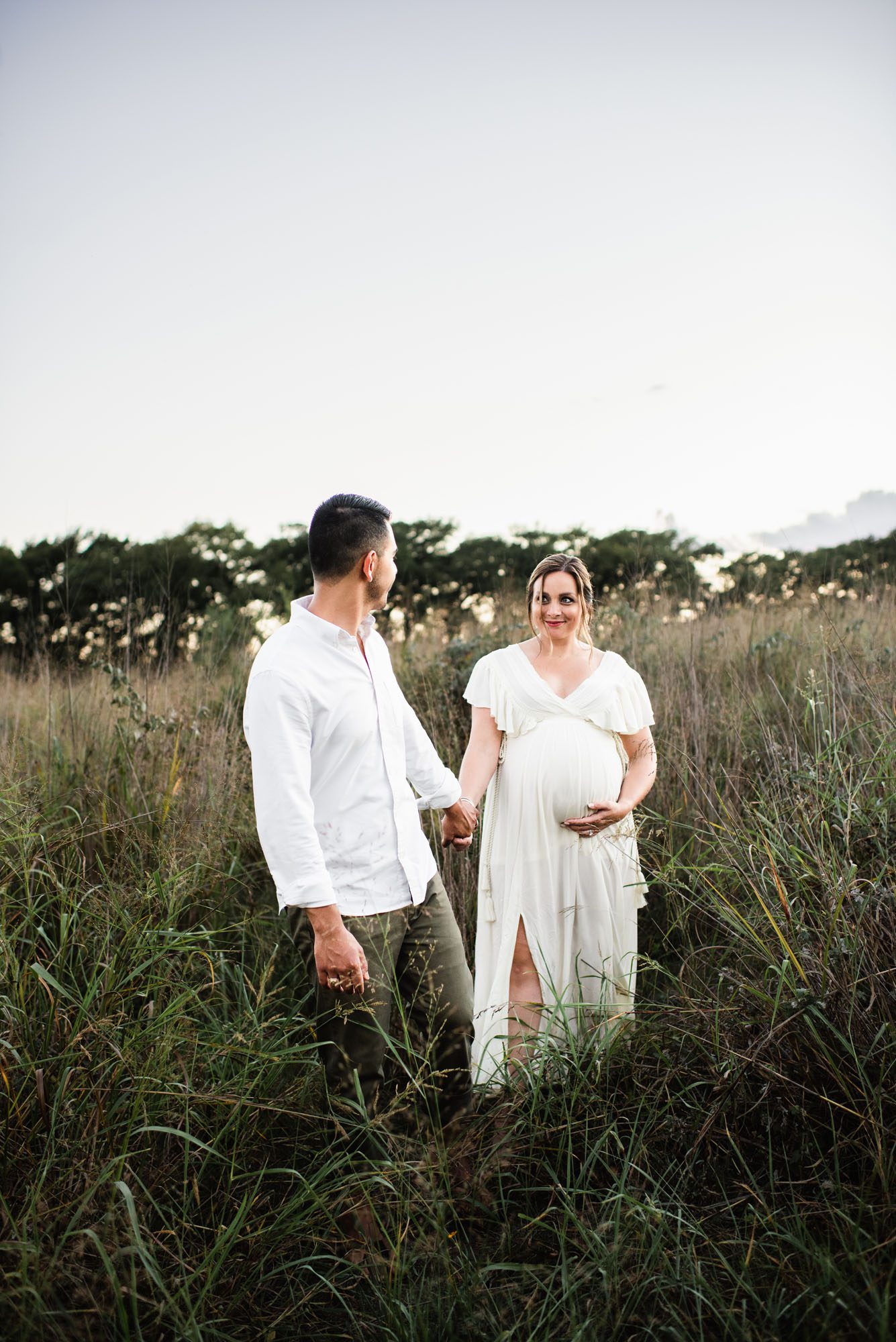 San Antonio Maternity Photographer, couple walking in the tall grass