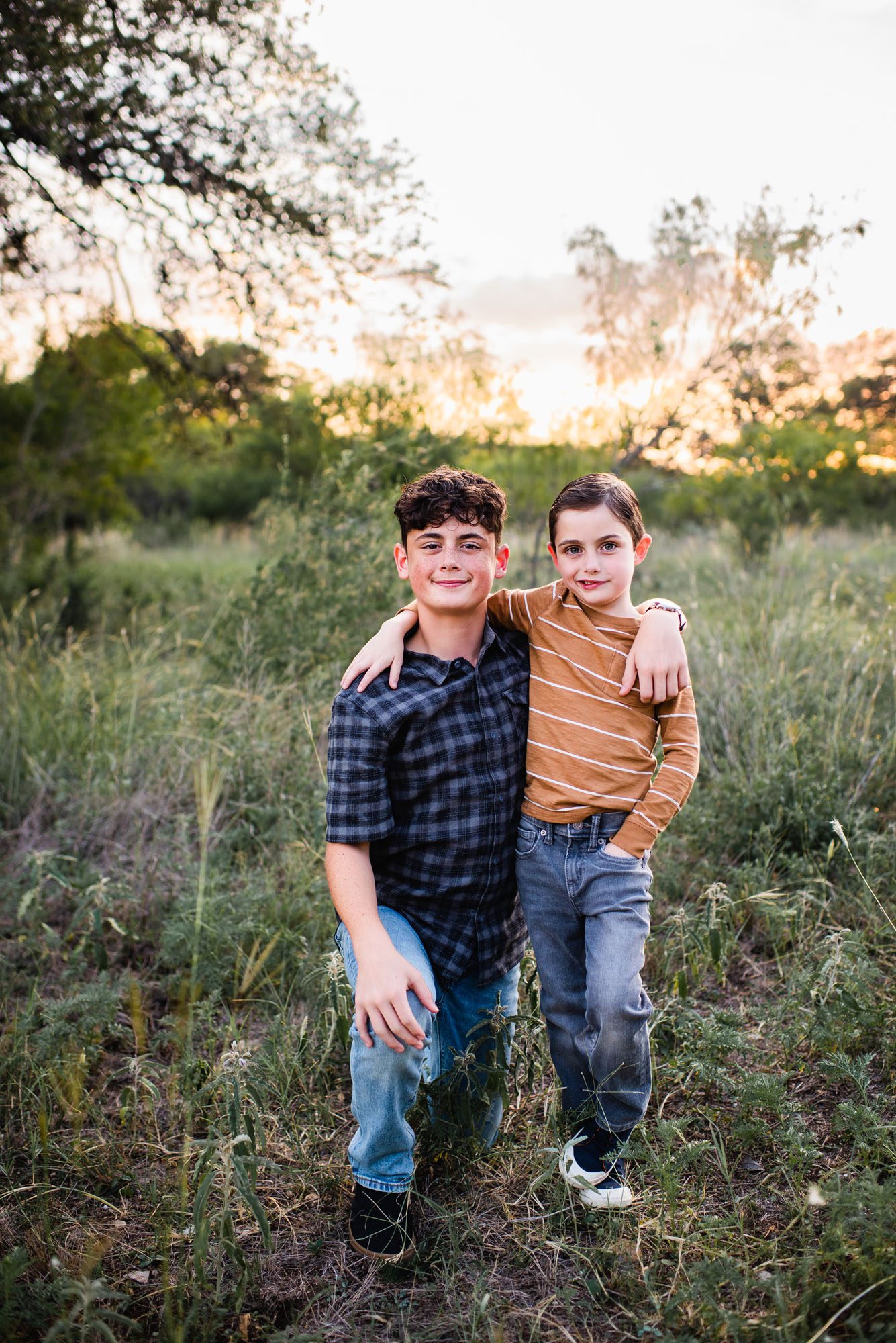 Brothers standing together in a field, San Antonio family photographer