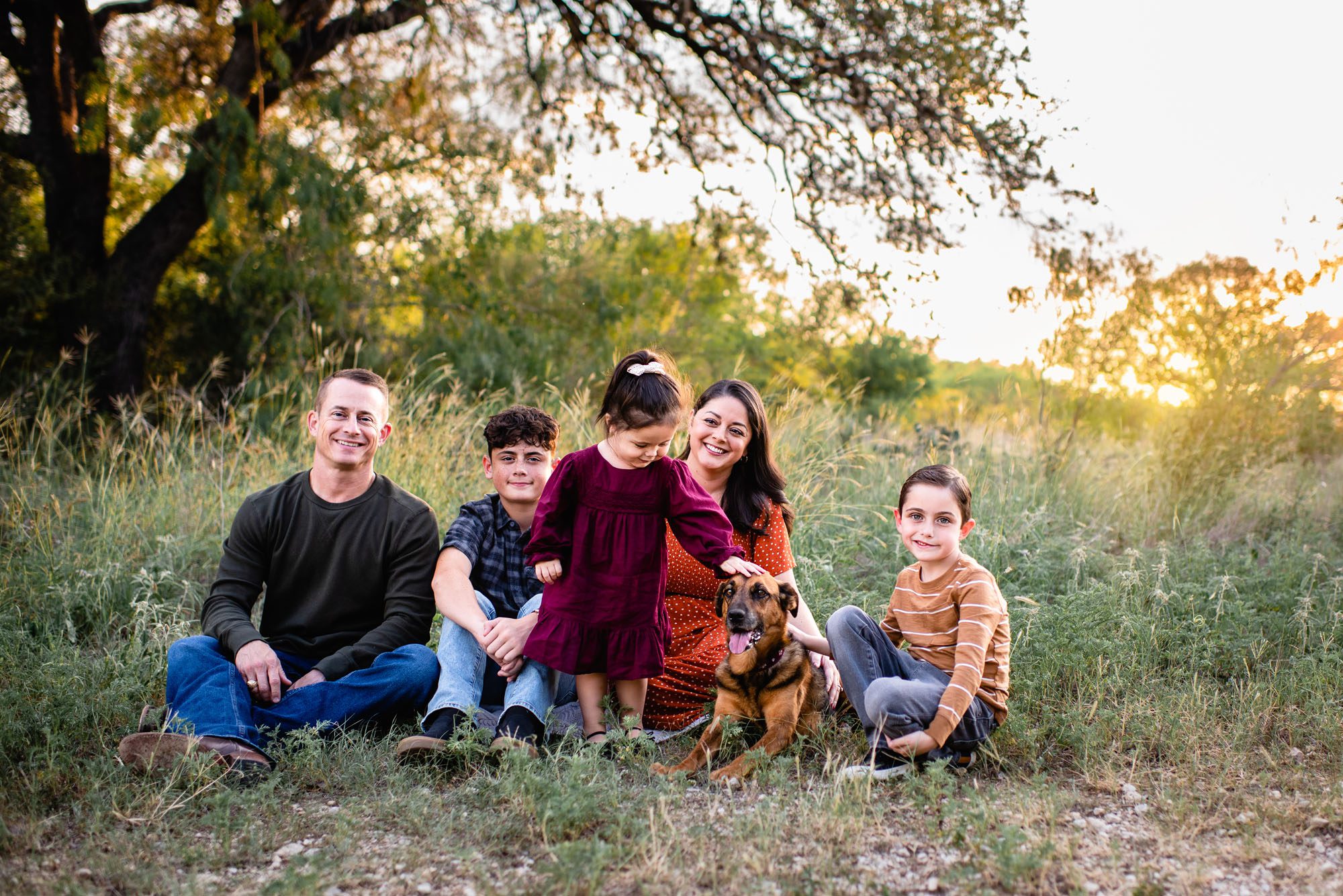 Family sitting with their dog at sunset, San Antonio family photographer