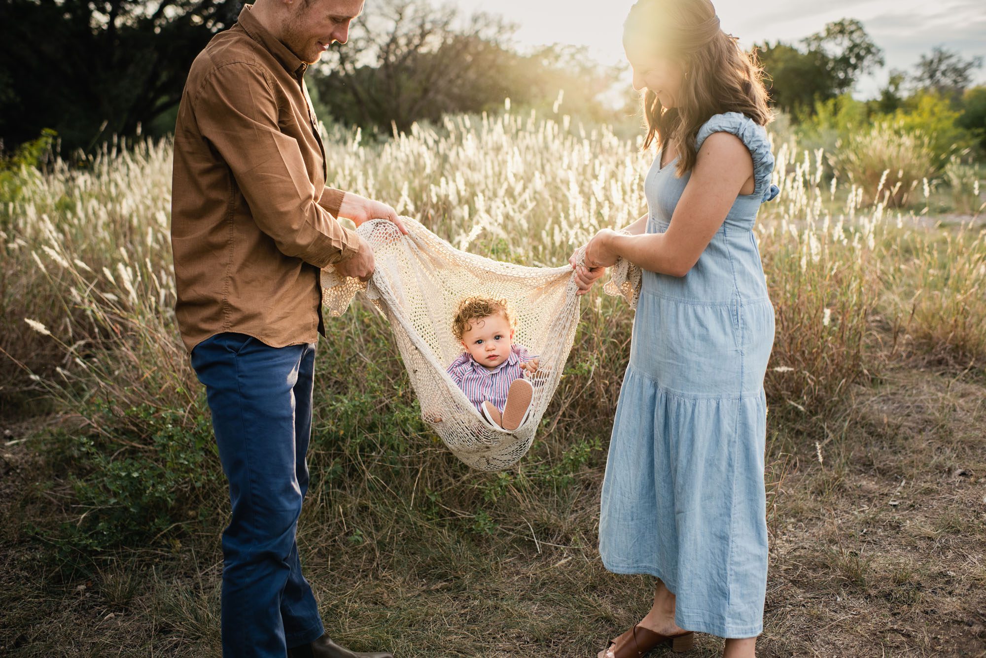 Parents swinging baby boy in blanket, San Antonio Family Photographer