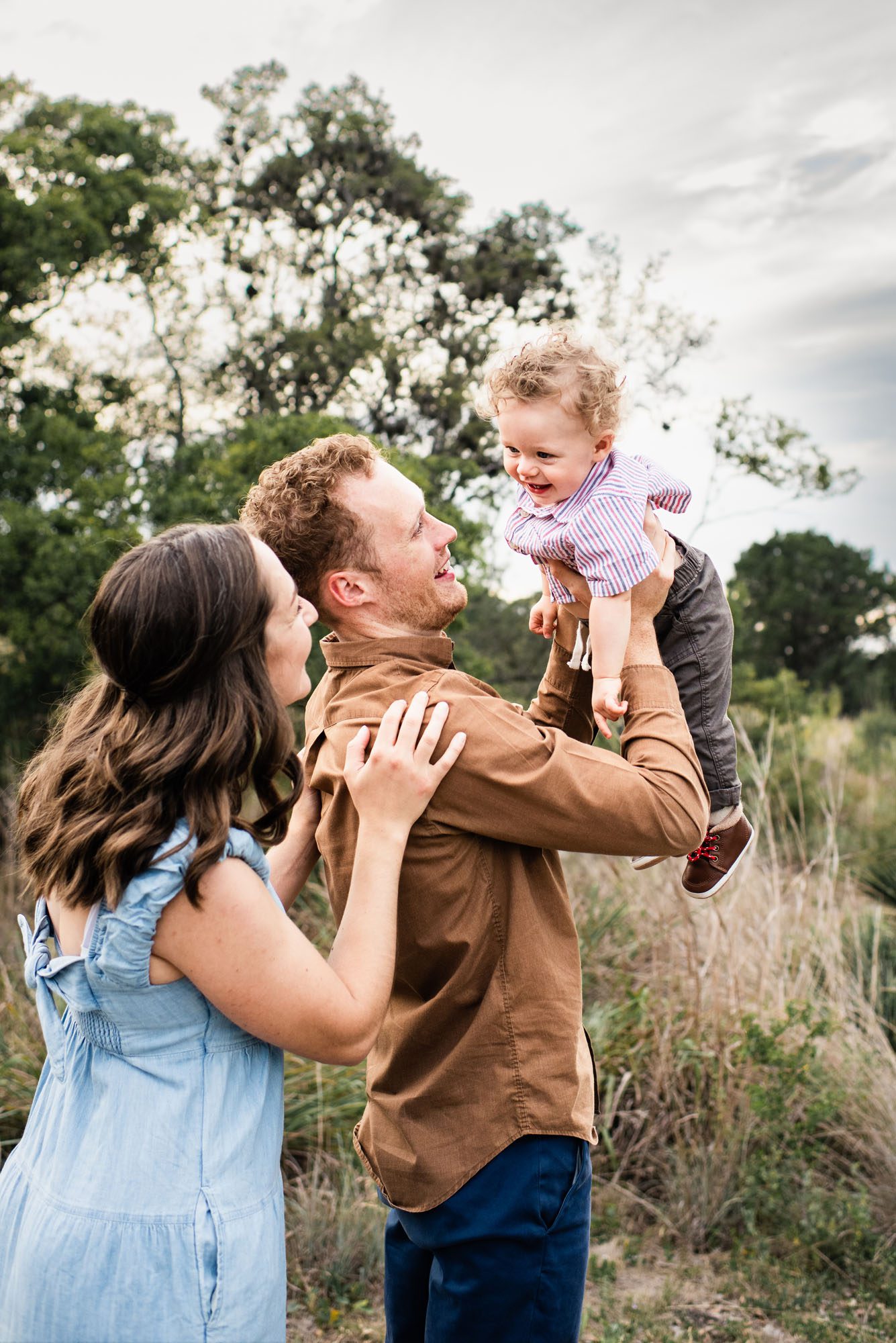 Parents holding up baby boy in a field, San Antonio Family Photographer