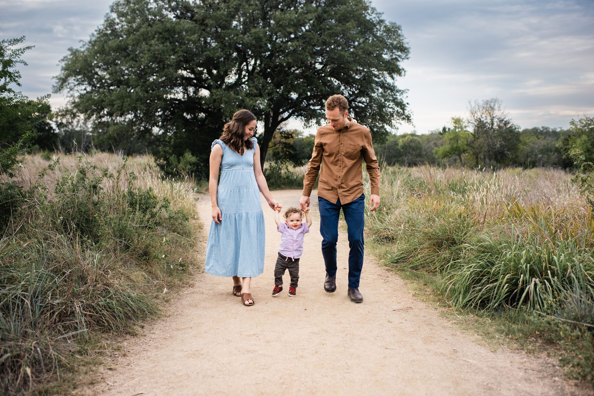 Parents walking with baby boy along path, San Antonio Family Photographer