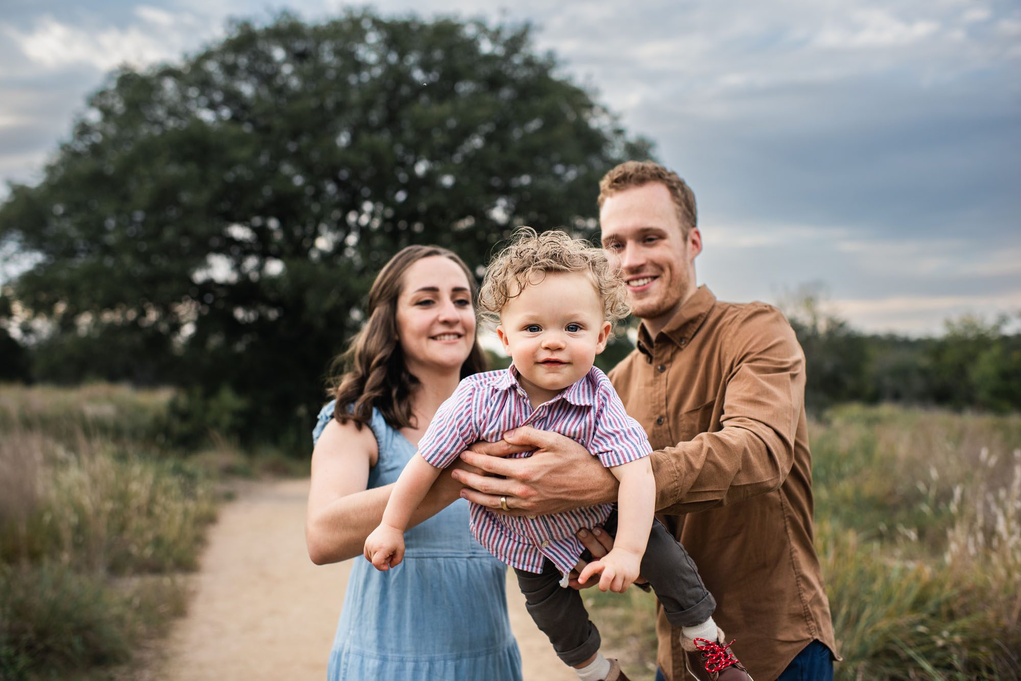 Parents holding baby boy up to the camera, San Antonio Family Photographer