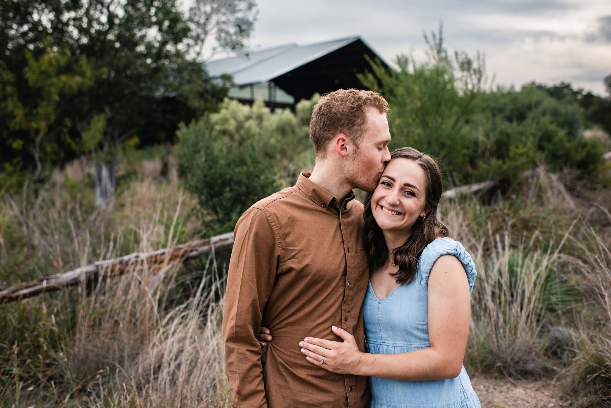 Couple kissing in a field, San Antonio Lifestyle Photographer