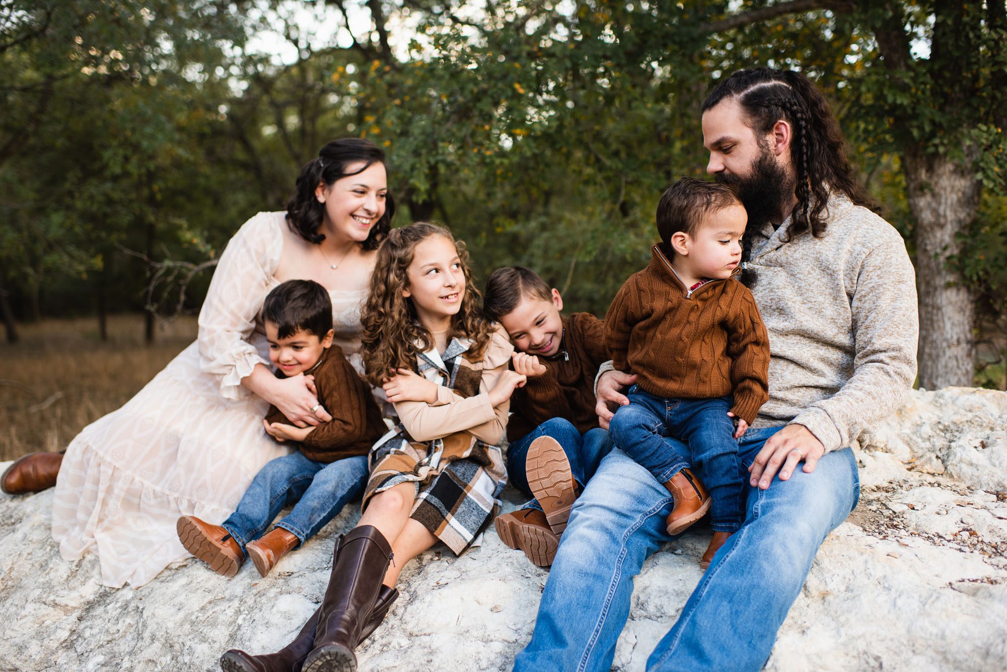 Family sitting on rock together, San Antonio Family Lifestyle Photographer