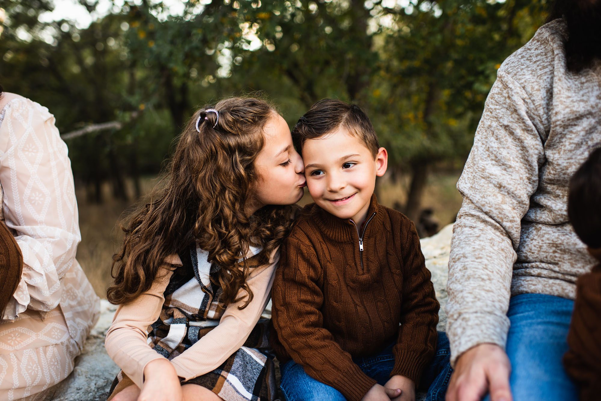 Close up of sister kissing brother on cheek, San Antonio Family Lifestyle Photographer