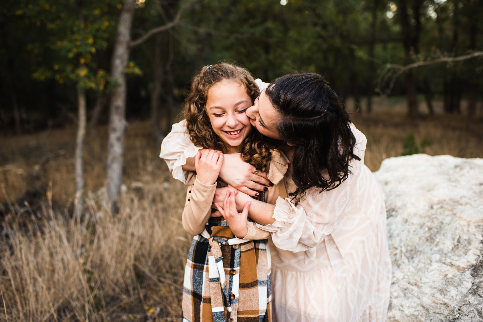 Mother hugging daughter and laughing, San Antonio Family Lifestyle Photographer